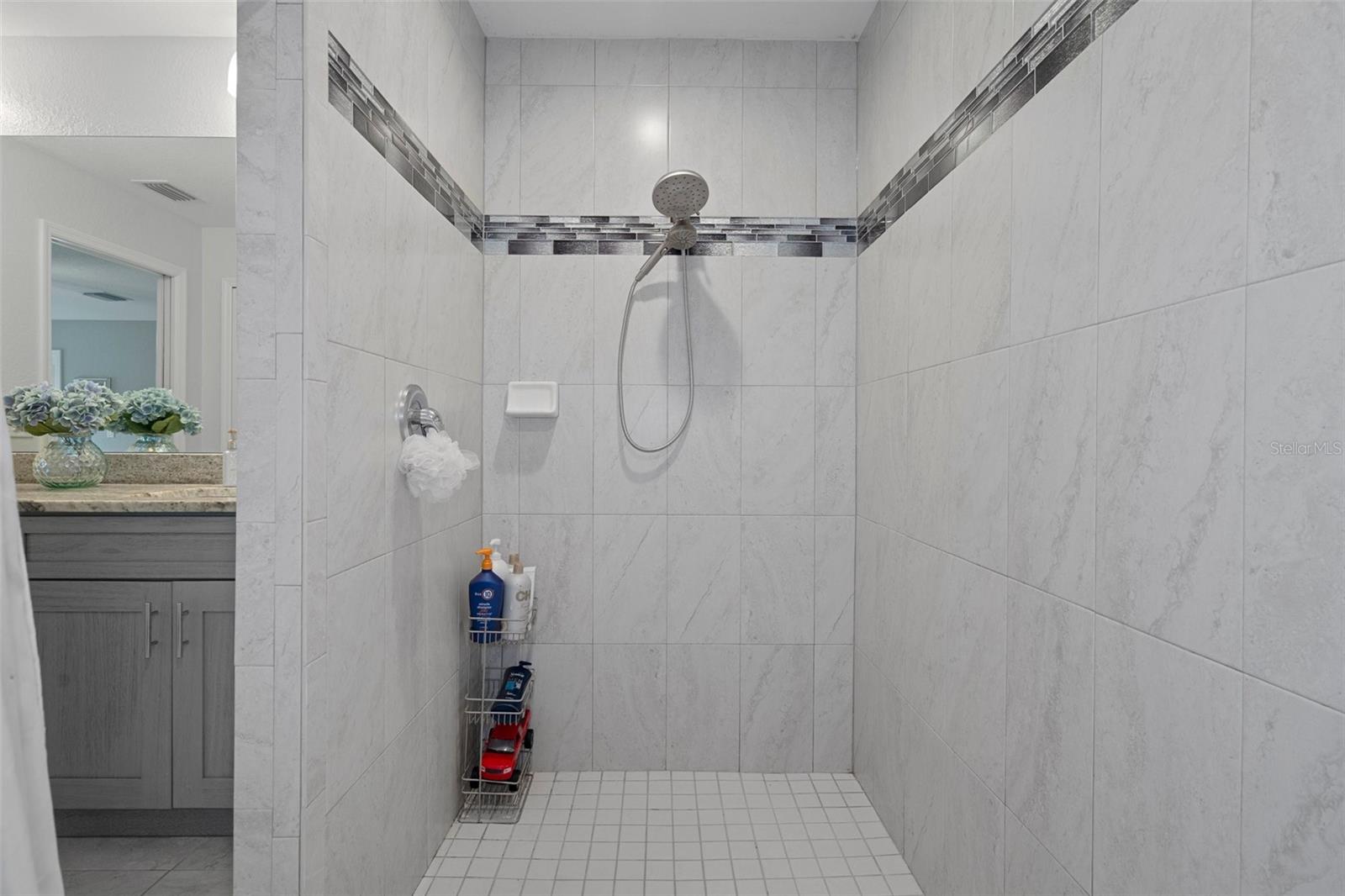 The 4 X 8 beautifully tiled shower has dual shower heads