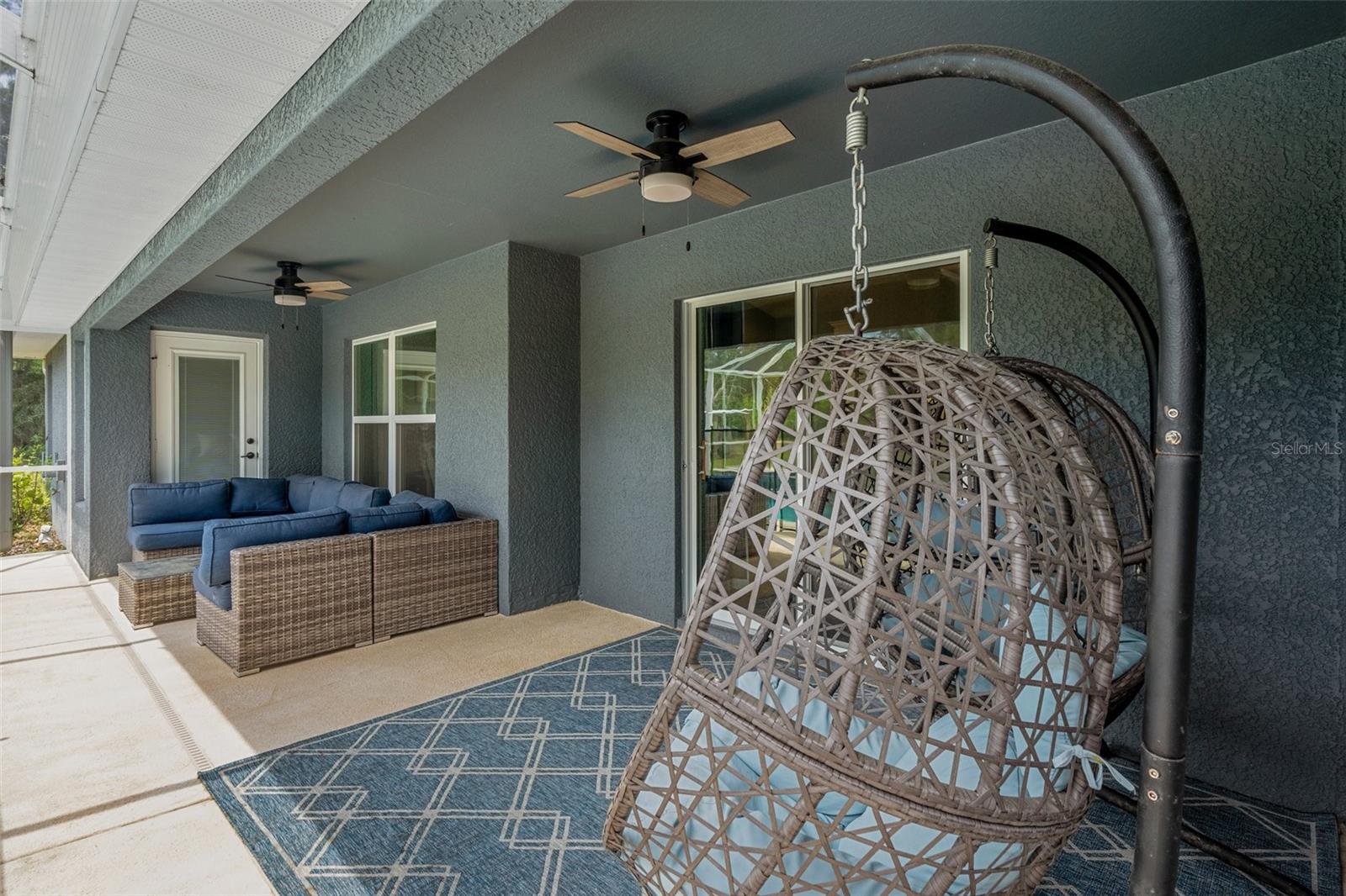 The covered porch open to the salt water pool is relaxing and wonderful