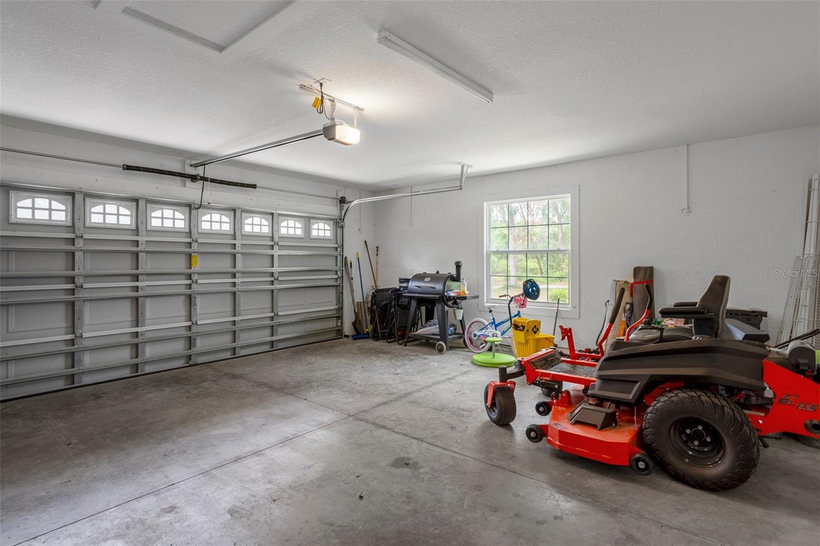 The garage door has windows allowing lots of natural light in