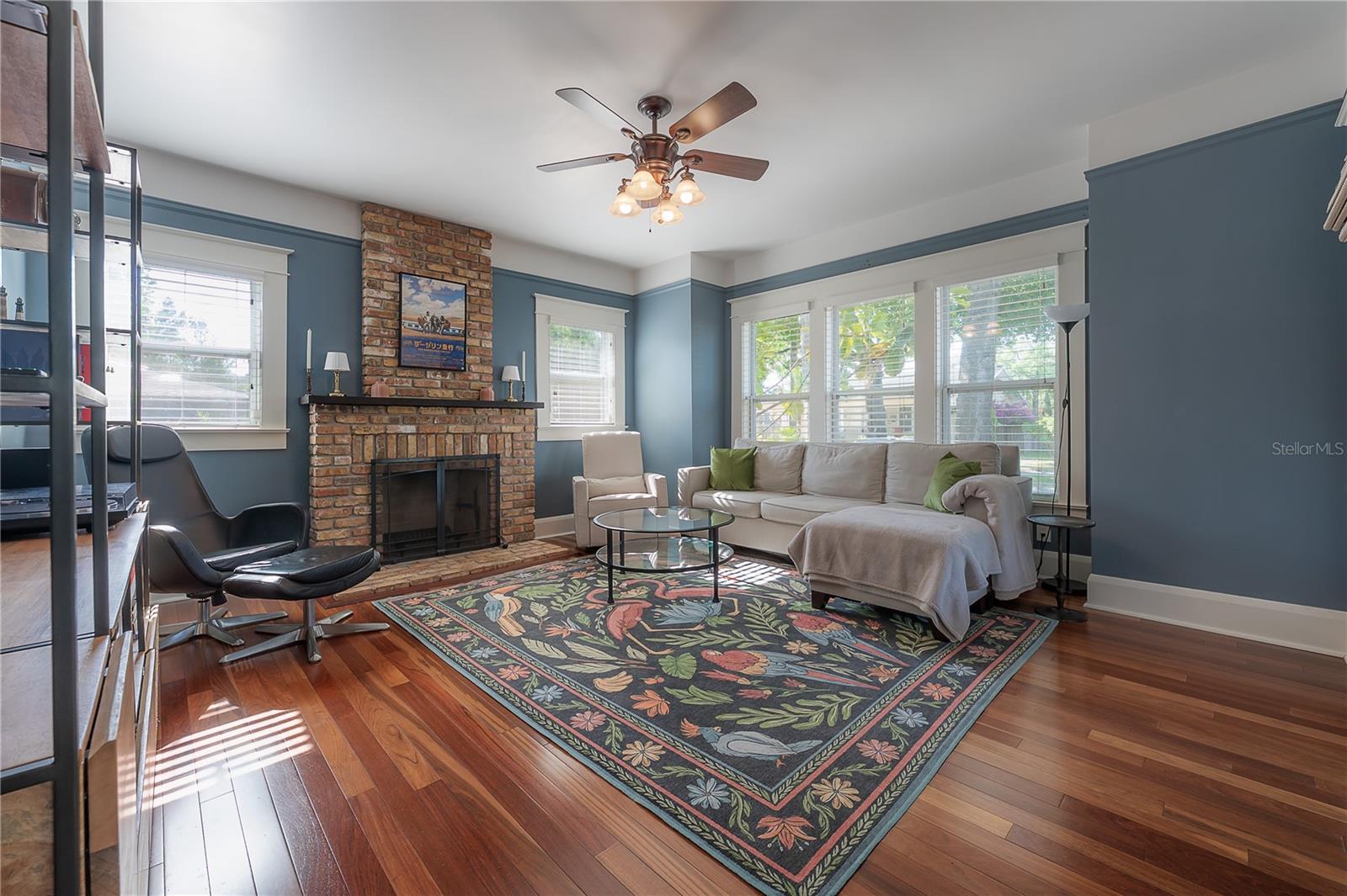 Stunning wood floors and a brick clad wood burning fireplace.