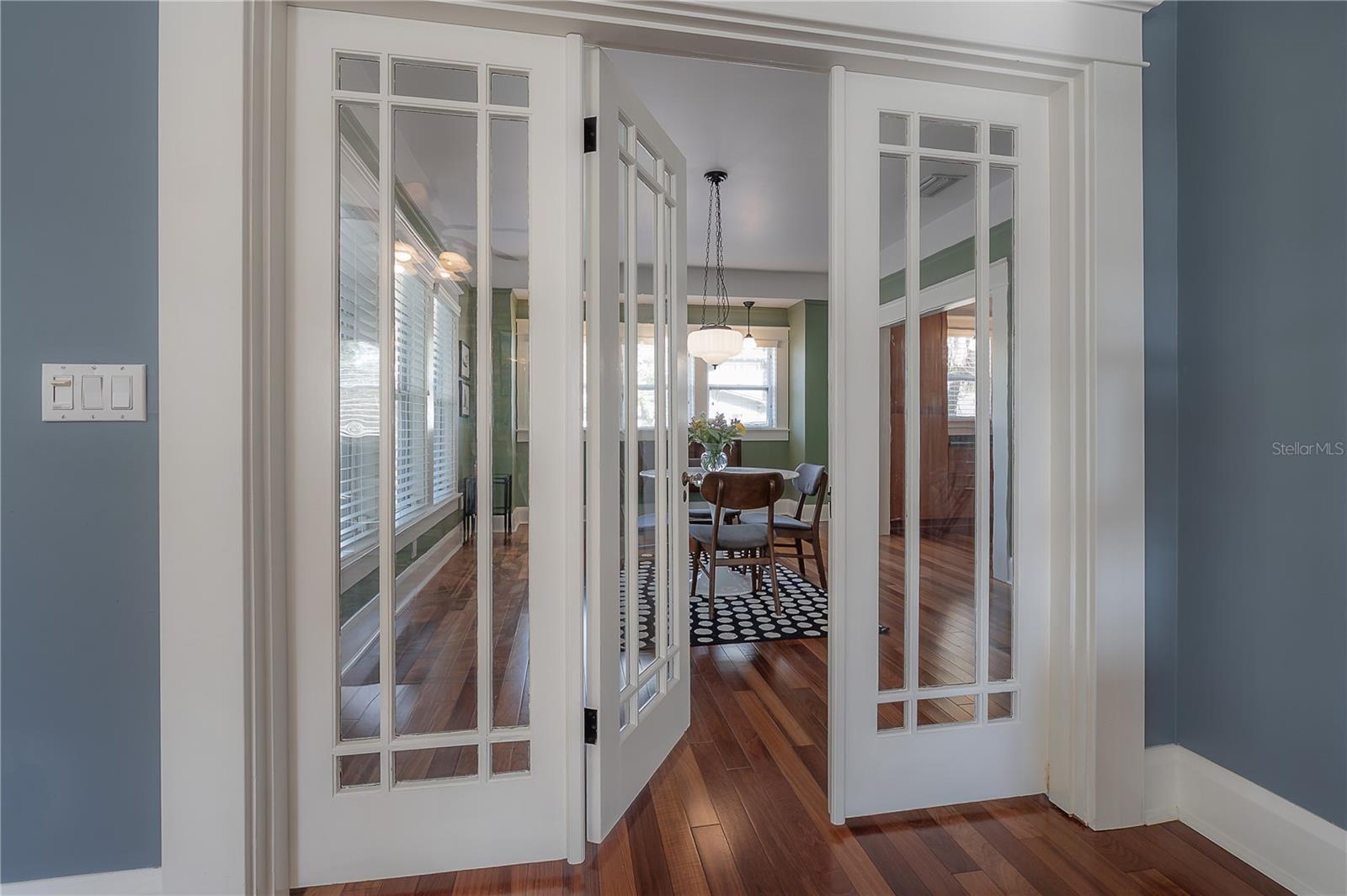 Original tri-fold french doors seperating the dining room from the living room. They can fold back to completely open!