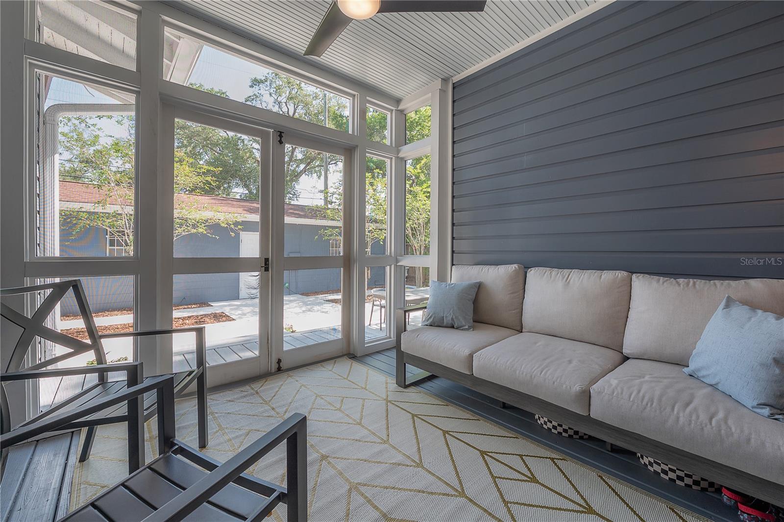 Completely screened in back porch, with a roof to protect from the sun.