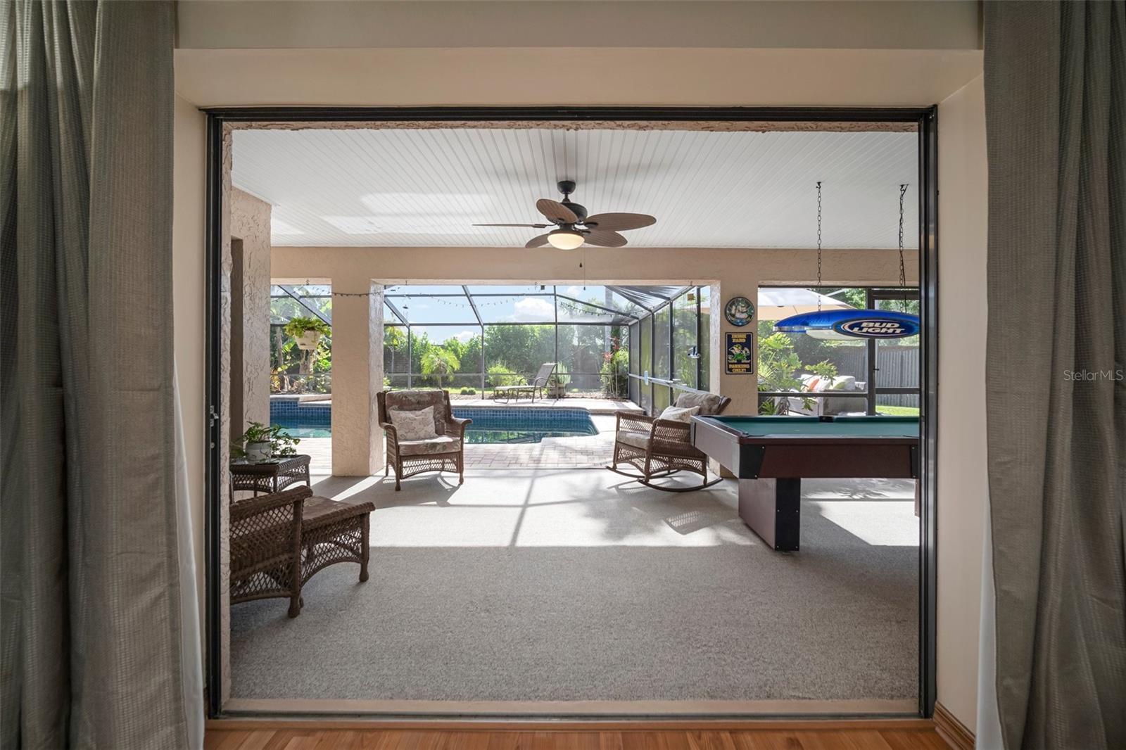 View from formal living area into spacious outdoor entertainment area