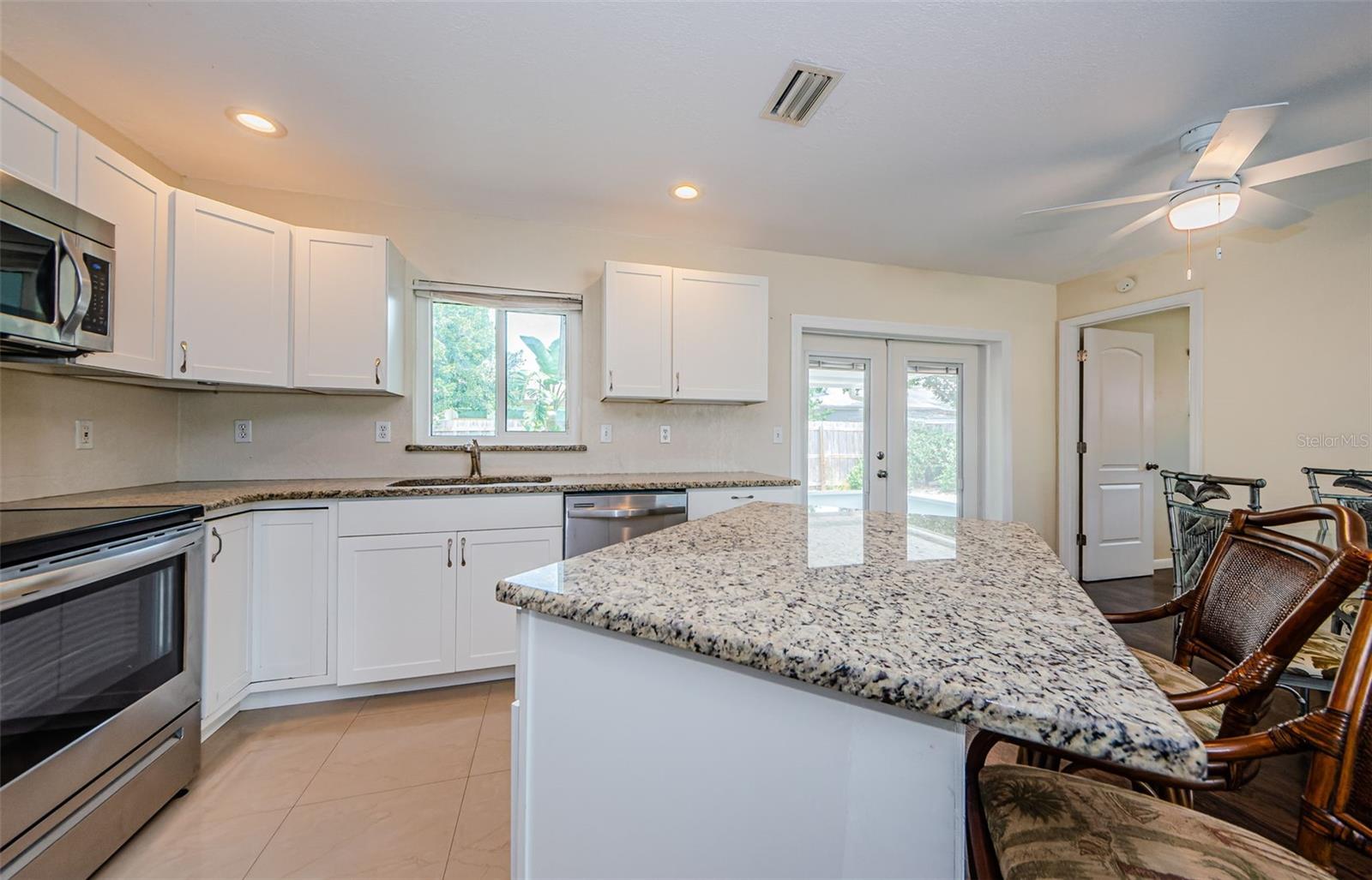 Gorgeous kitchen with stainless appliances and stone counter tops.