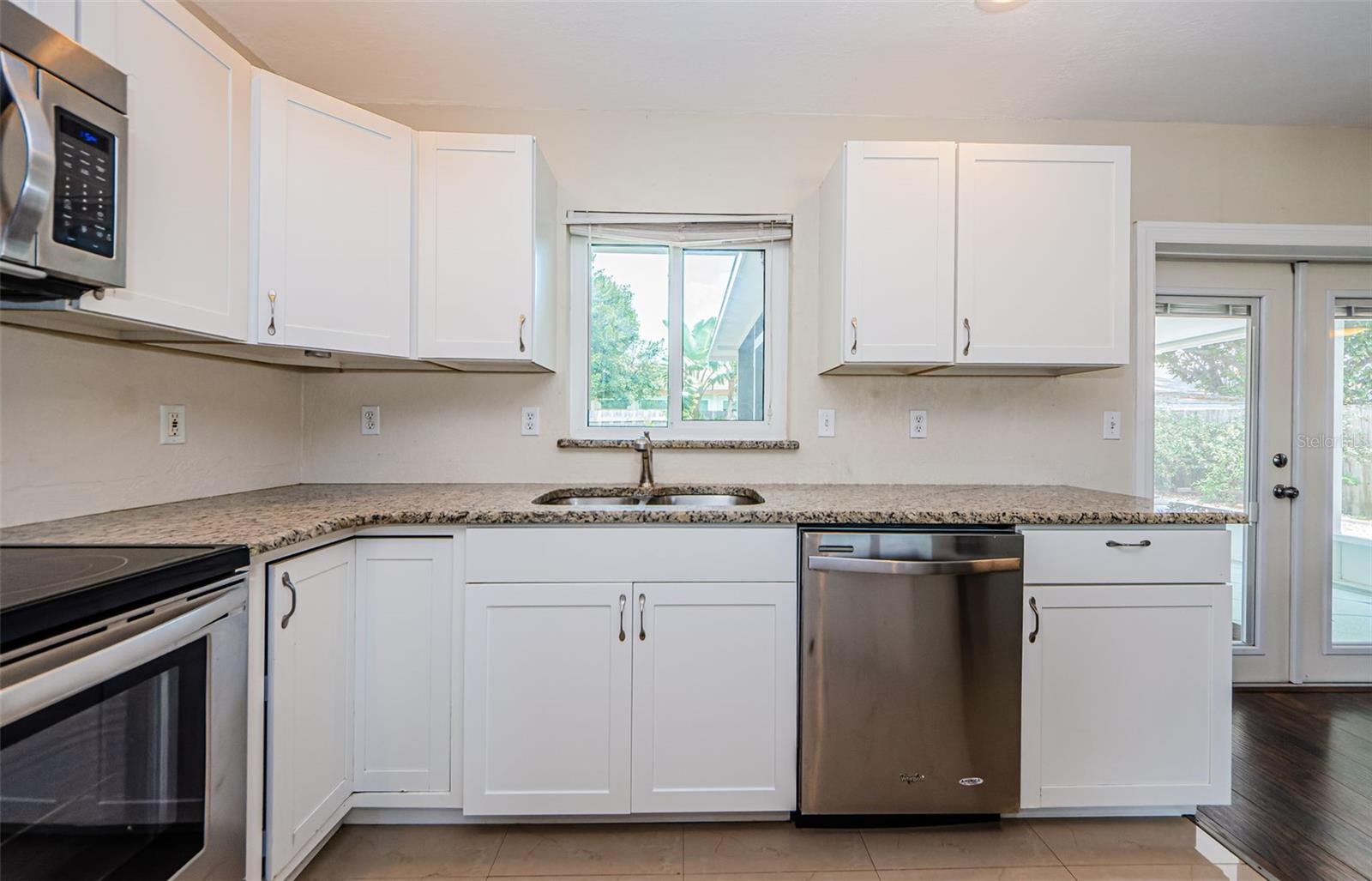Shaker style cabinets in kitchen.  Window to backyard.