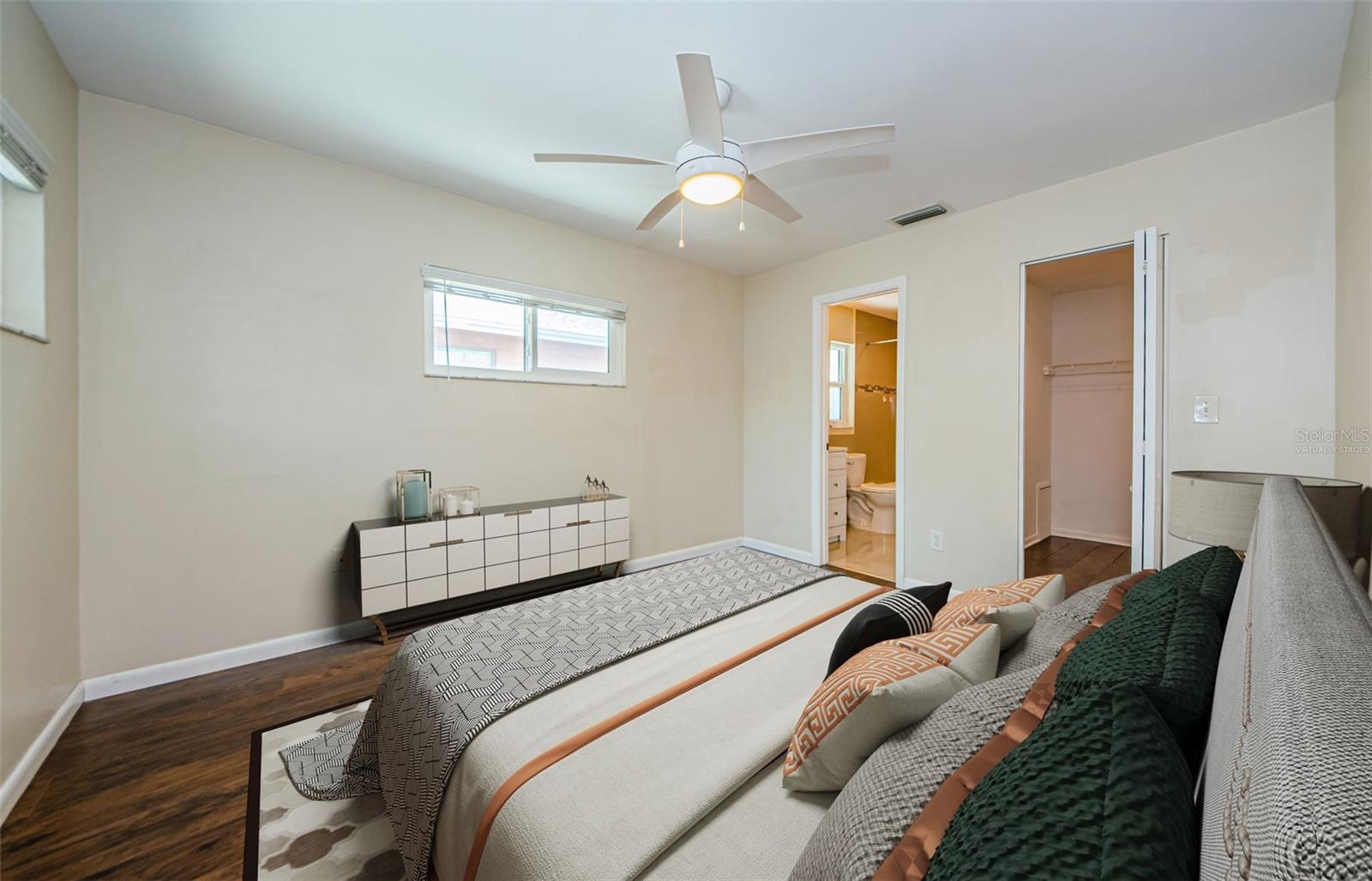 Virtually staged image of primary bedroom with large walk in closet and ensuite.