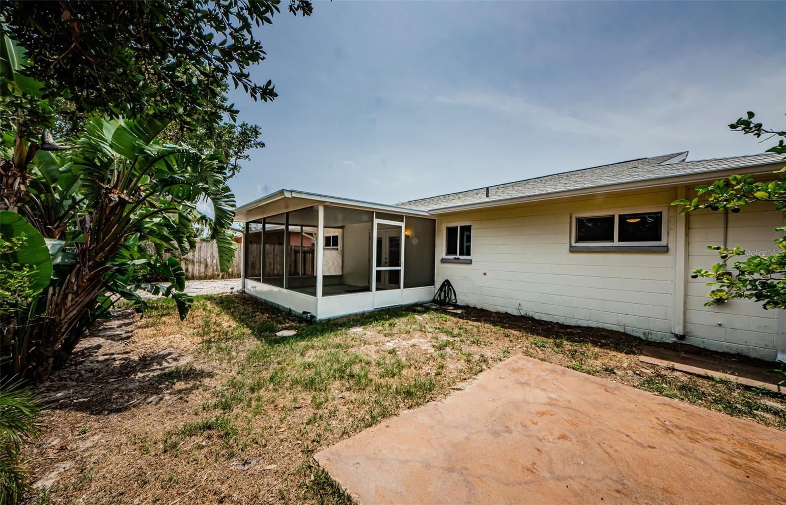 View of back yard with updated screened porch.
