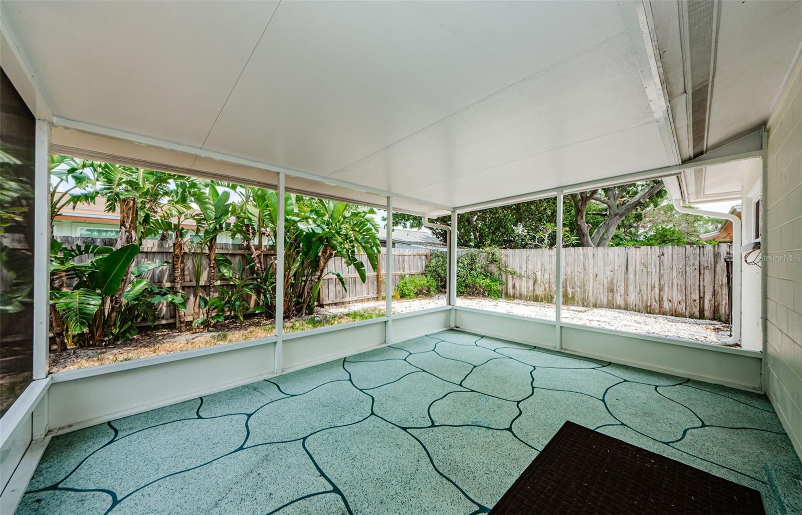 Screened and covered porch in backyard.