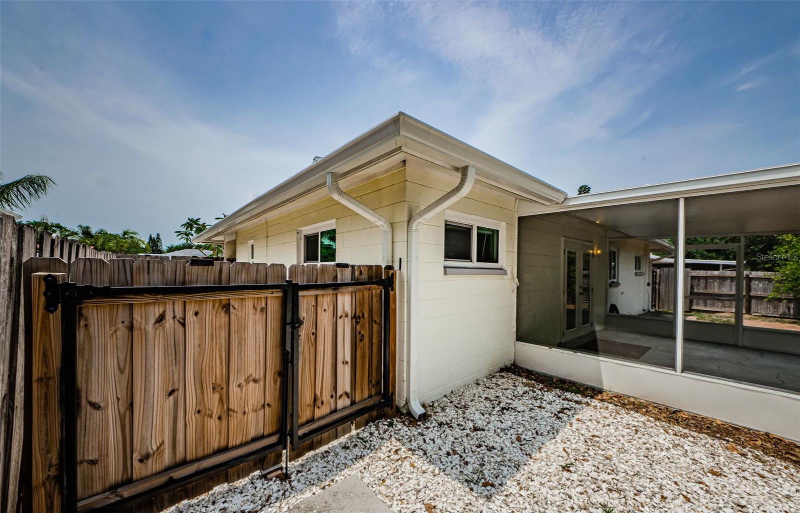 Additional gated area on side of house for storage or pets