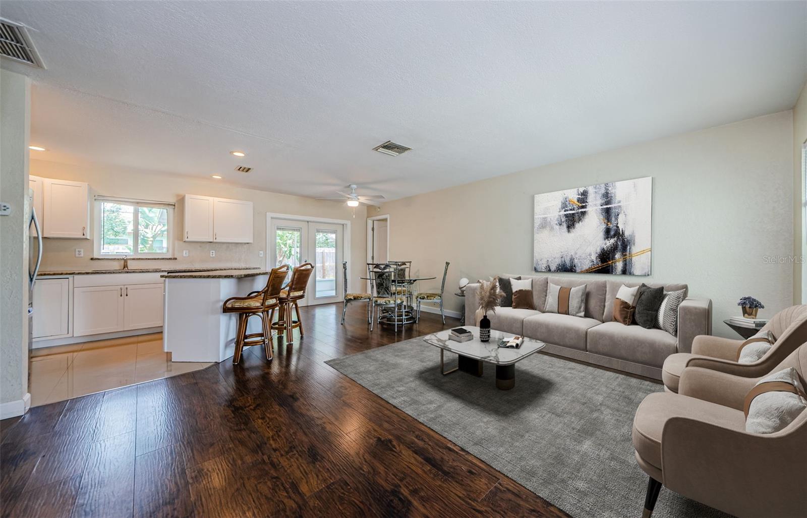 Virtual staged image of living room, dining and kitchen with island