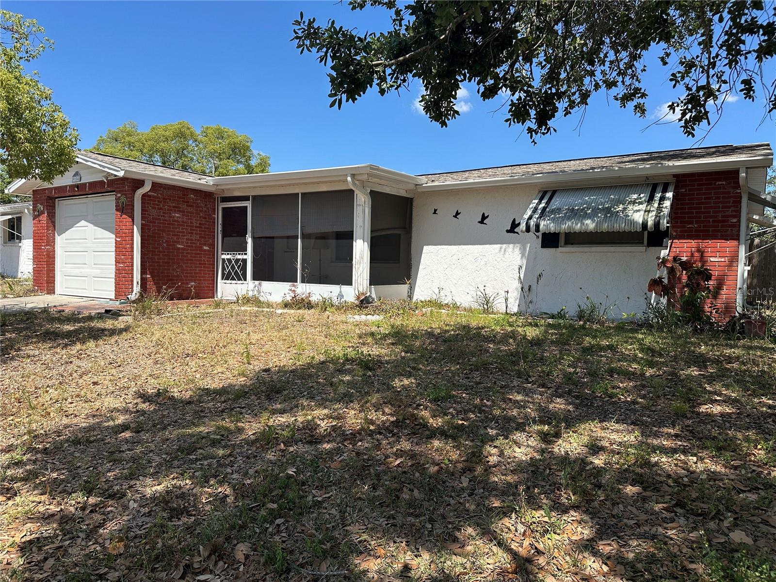 Front elevation of the home with screened front porch