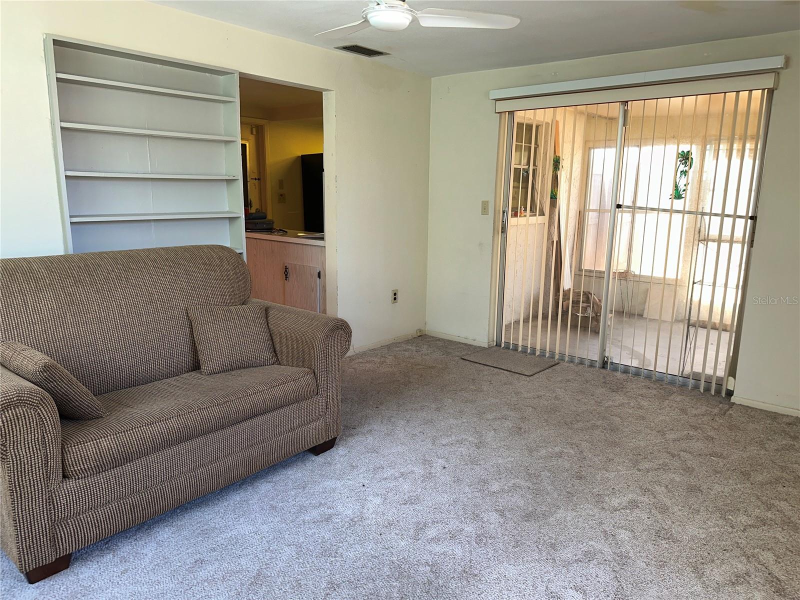 View of the family room looking towards the sliding glass door out to the screened porch