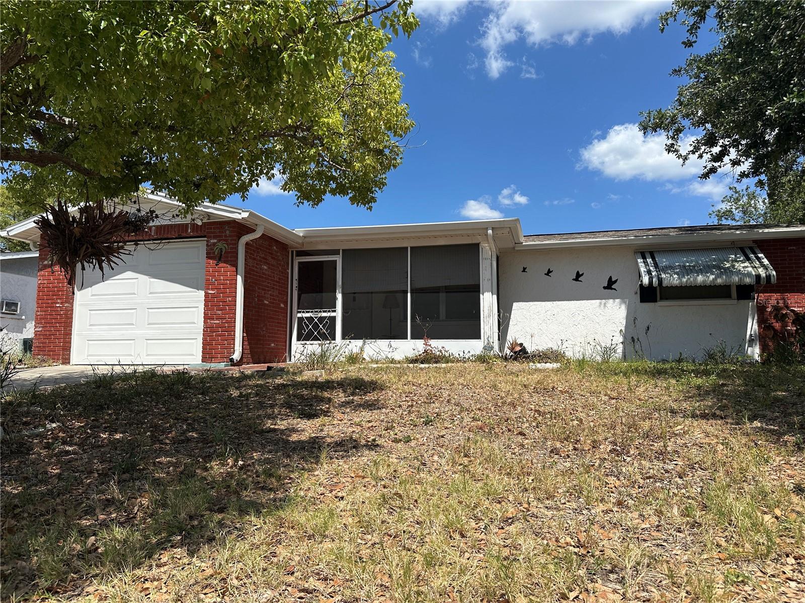 Straight on view of the front elevation with screened front porch
