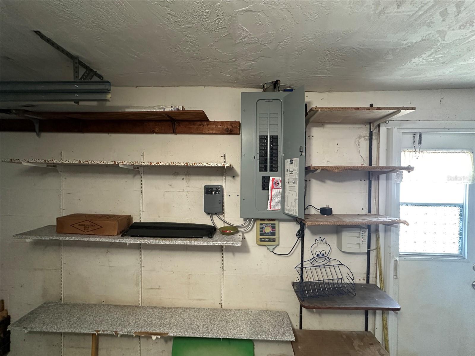 Built in shelving and Newer, Updated electrical panel in the garage