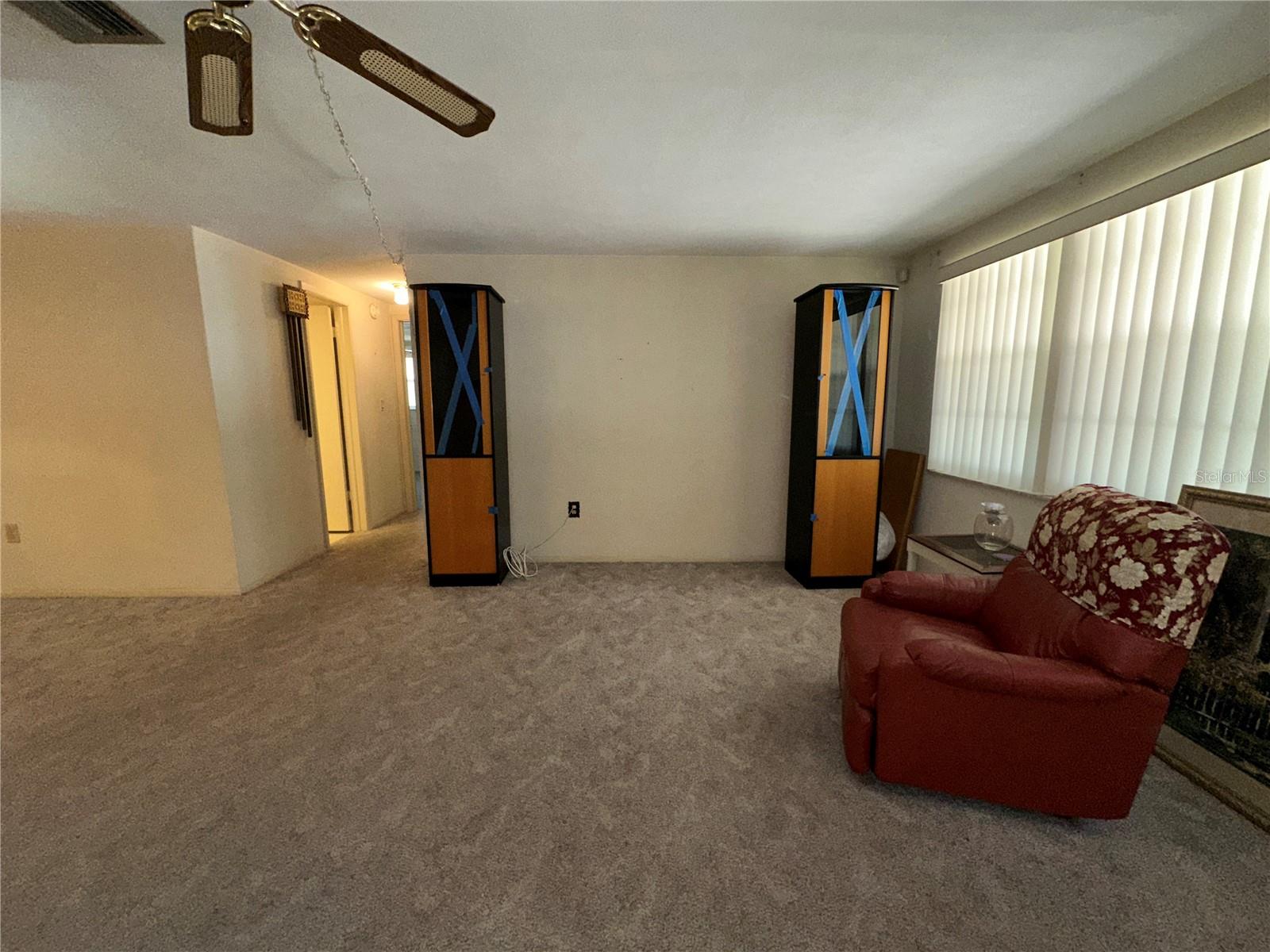 View of the living room just inside the front door looking at tv area