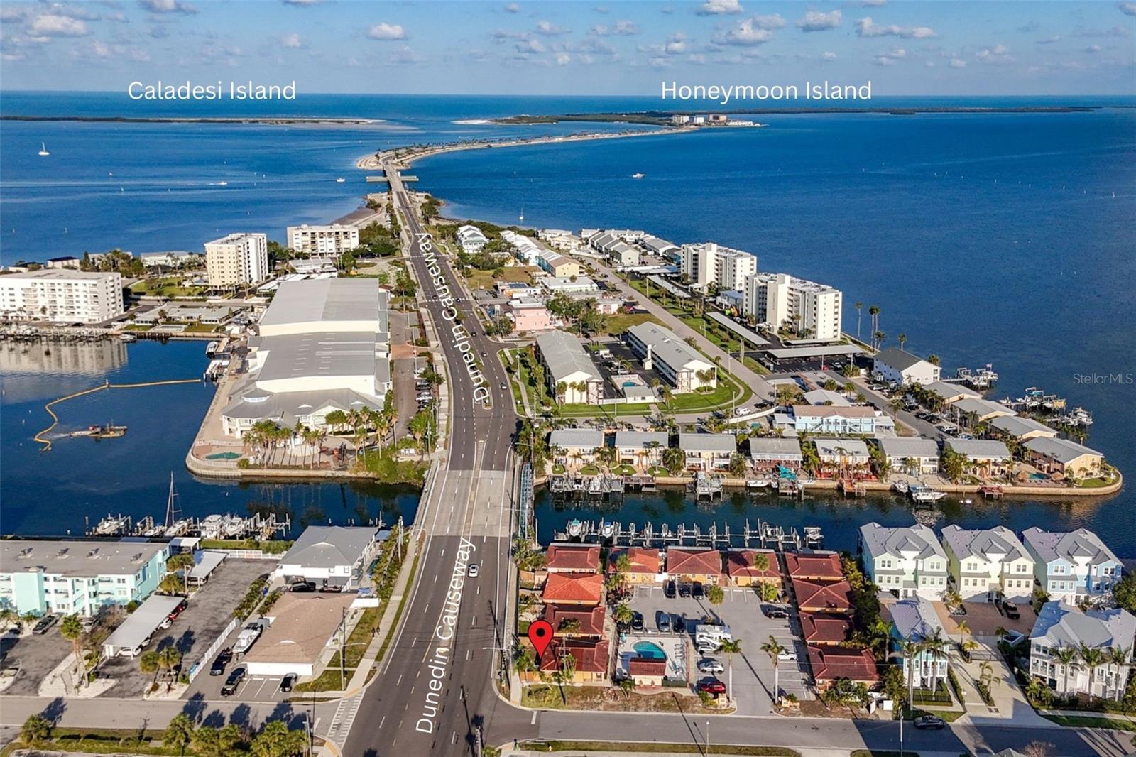 RED LOCATION DOT: 2600 N Paula Dr Unit 2B: Aerial View West to Dunedin Causeway and Honeymoon Island