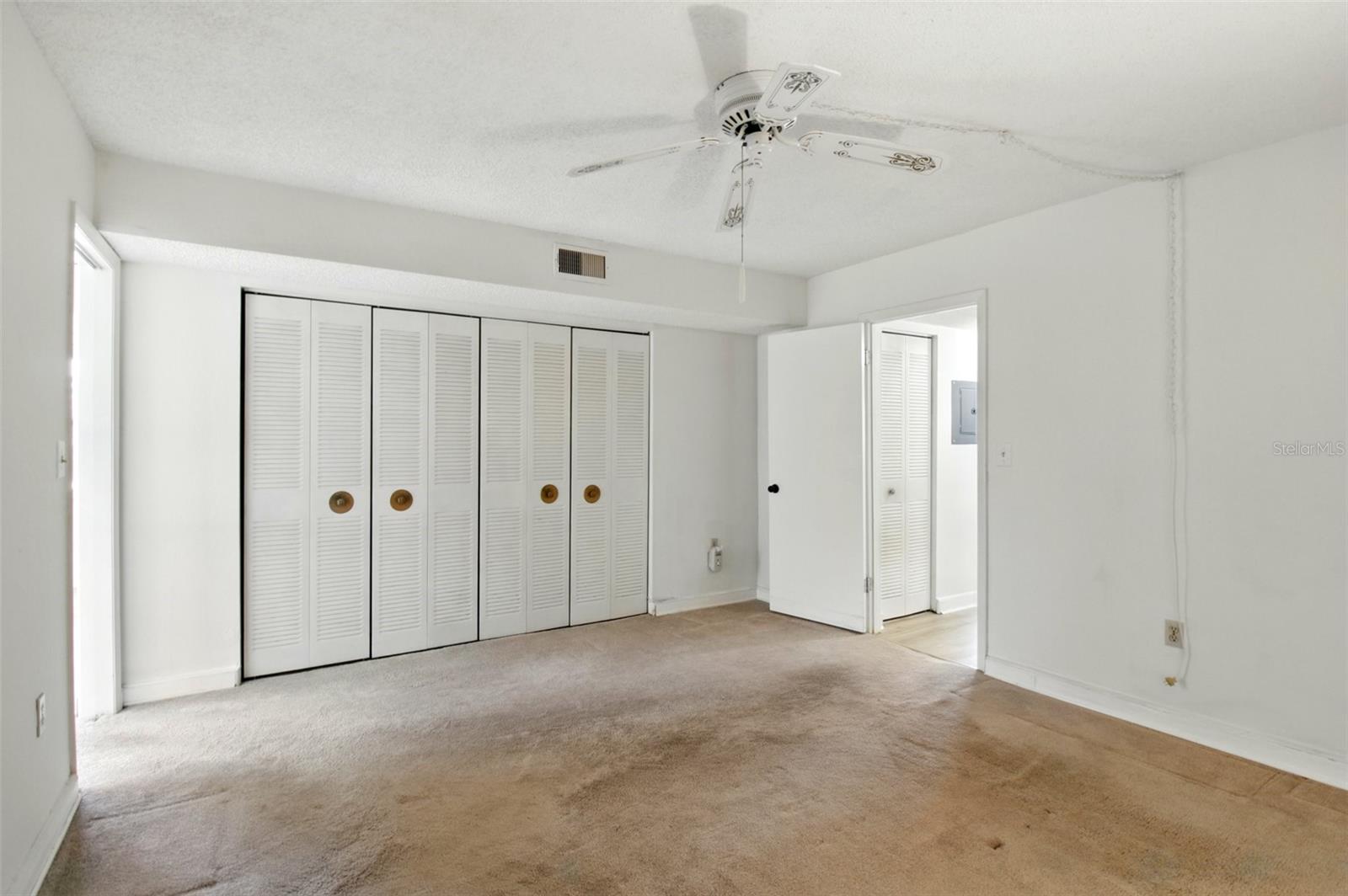 Primary bedroom with full wall of closets