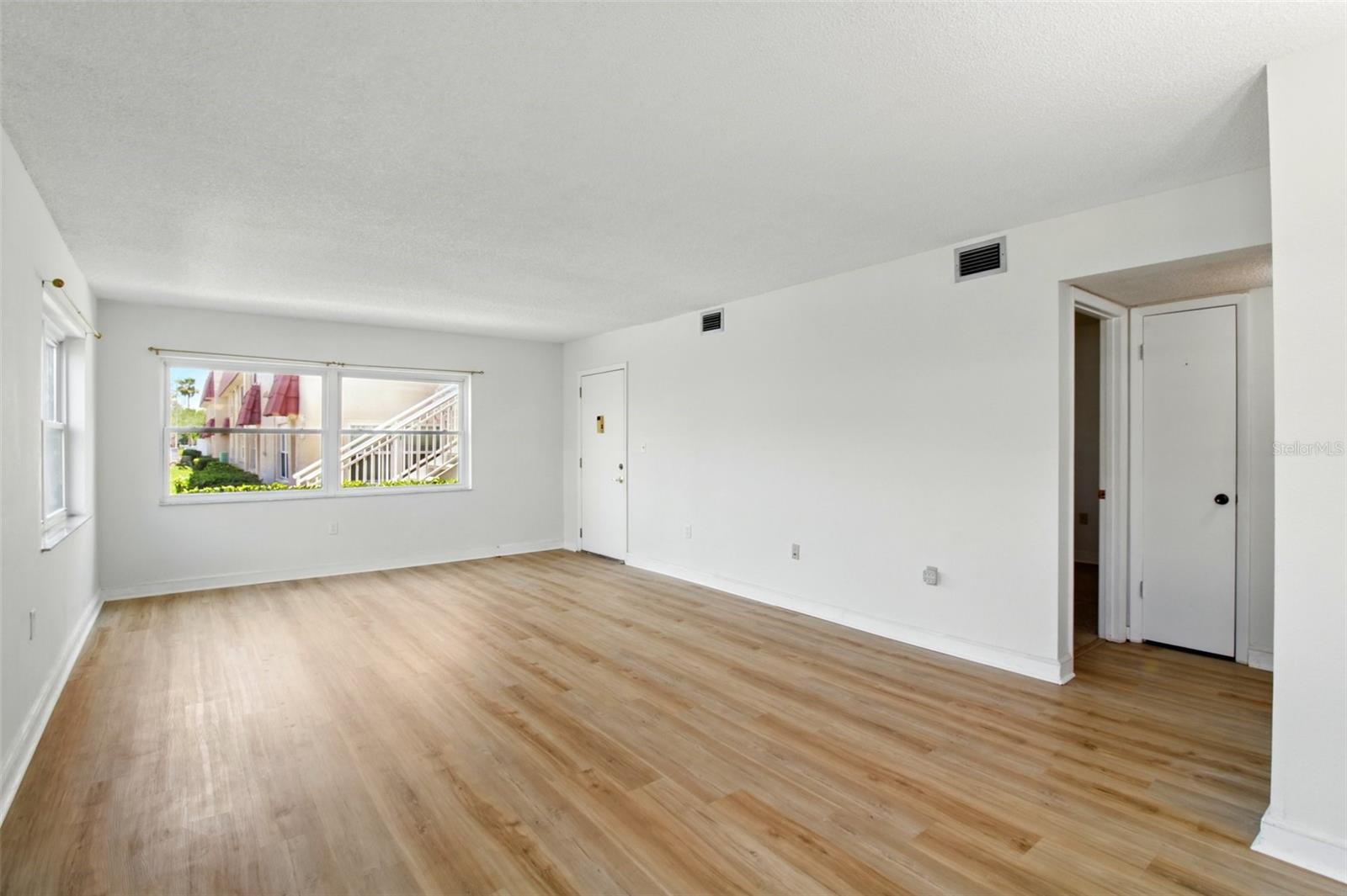 Living Room towards entry door - new laminate flooring
