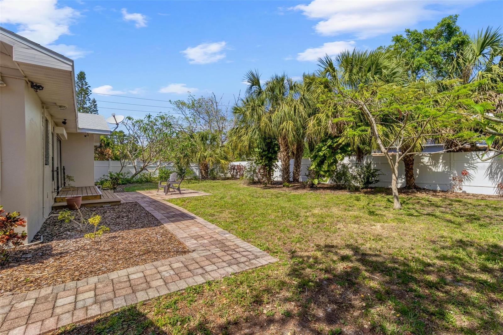 The back yard has tropical plantings and is fully fenced.