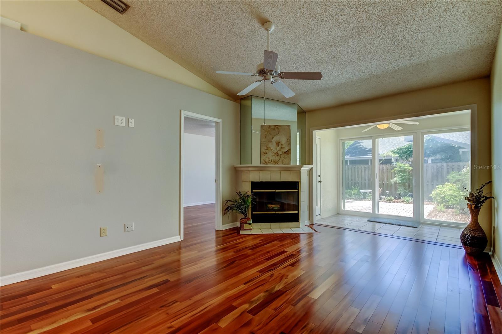 35.  Living Area (12.6 x 14.11') w Wood Burning Fireplace! Opens to Bonus Area (8.1 x 9.11')! Right off Mbdrm!