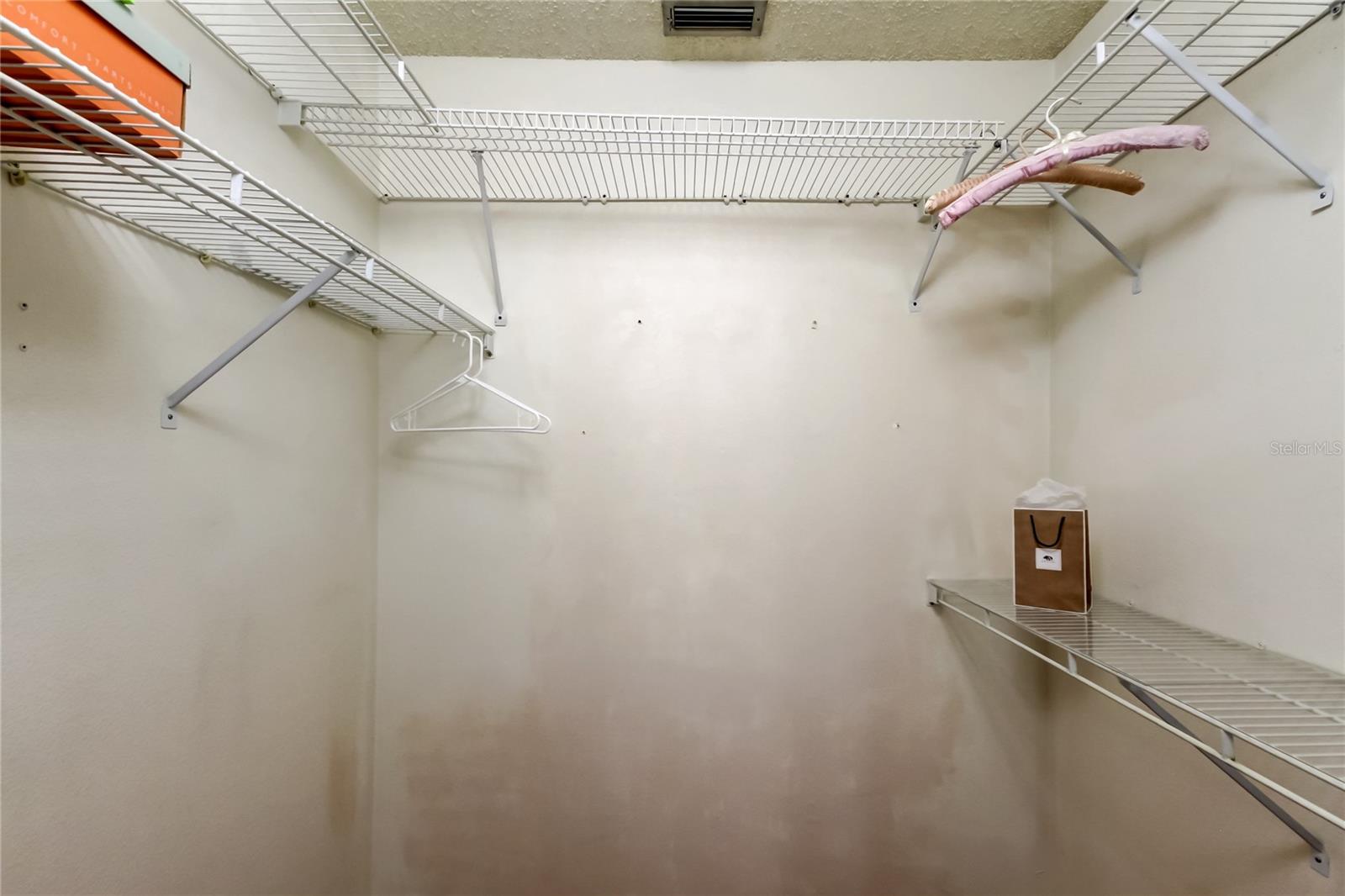 45. Owners Retreat Walk In Closet (5.4 x 5.11') is Grandiose! Double Tiered Shelves Line the Walls..