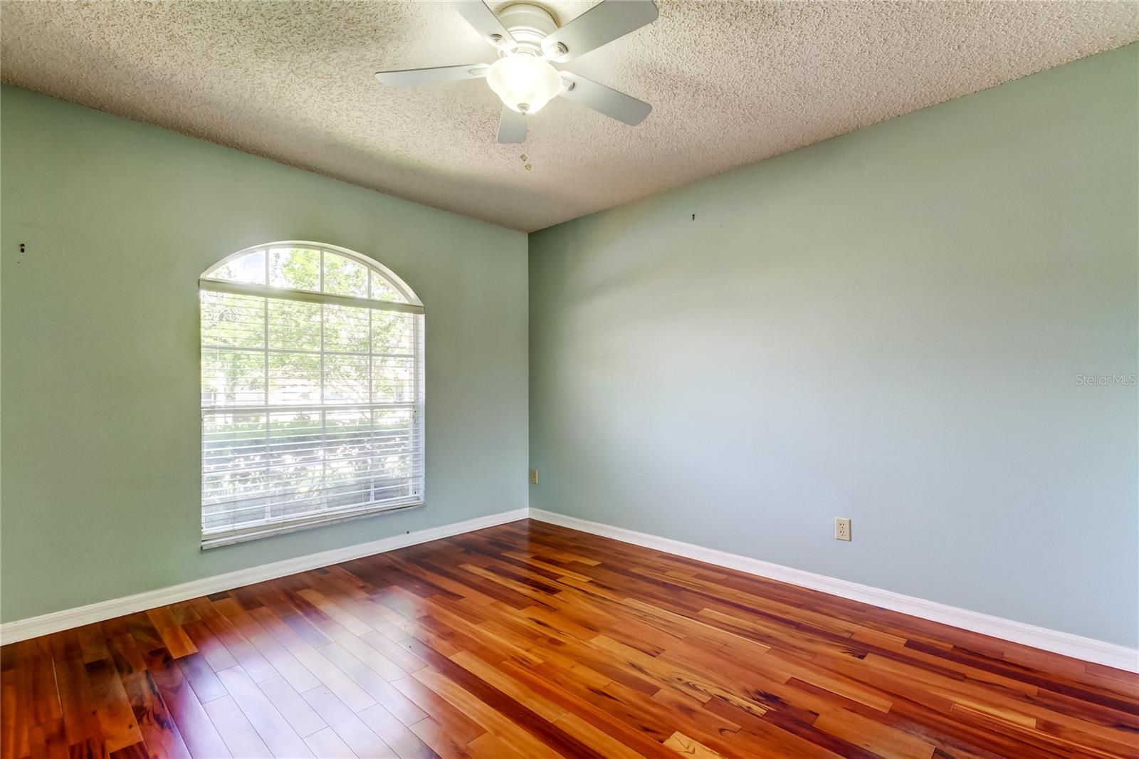 51. Bedroom #2 (11.1 x 11.1') is at Front of Home, Close to Hallbath, Painted a Calming Blue w Ceiling Fan & Arched Window!!