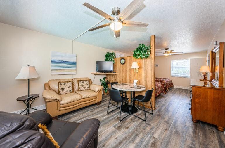 THE LIVING AREA IS SEPARATED FROM THE BEDROOM