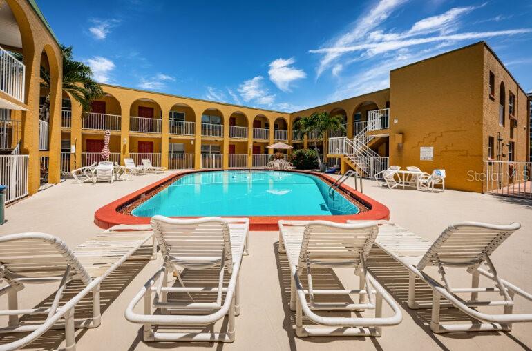 ROOM 12 IS UPSTAIRS BEHIND THE PALM TREE TO THE RIGHT