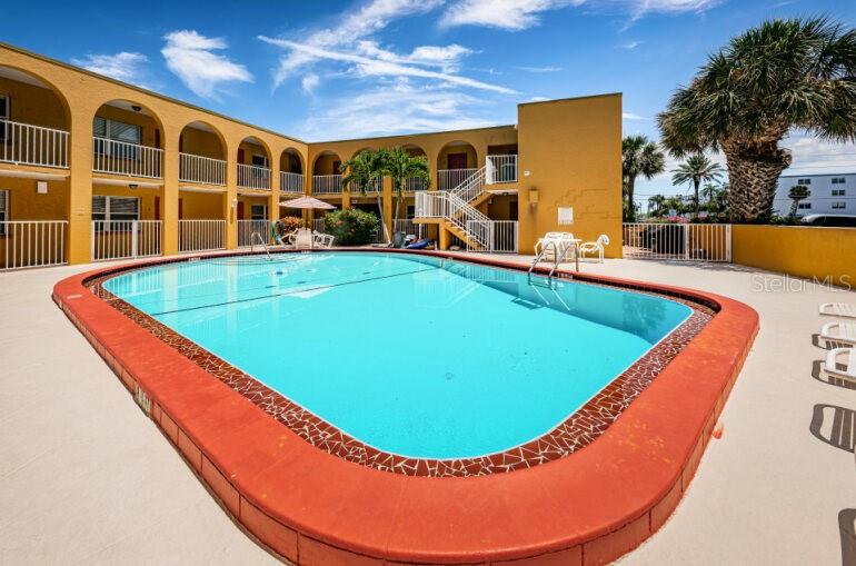 ROOM #12 IS RIGHT BEHIND THE PALM TREE.