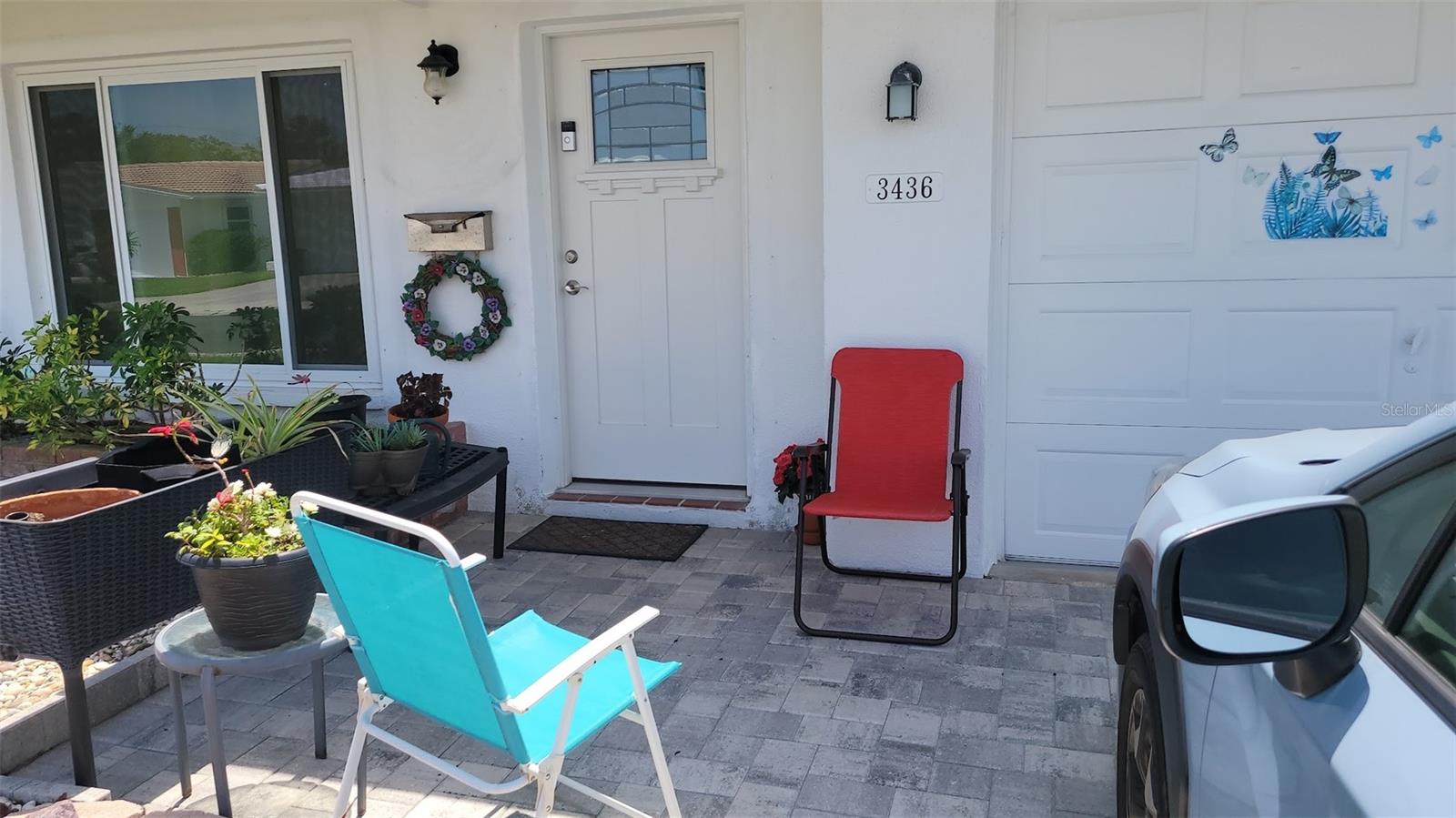 Enter into the home from this cute front paver patio. Notice the Front Door and the IMPACT WINDOWS that were both installed in 2022.