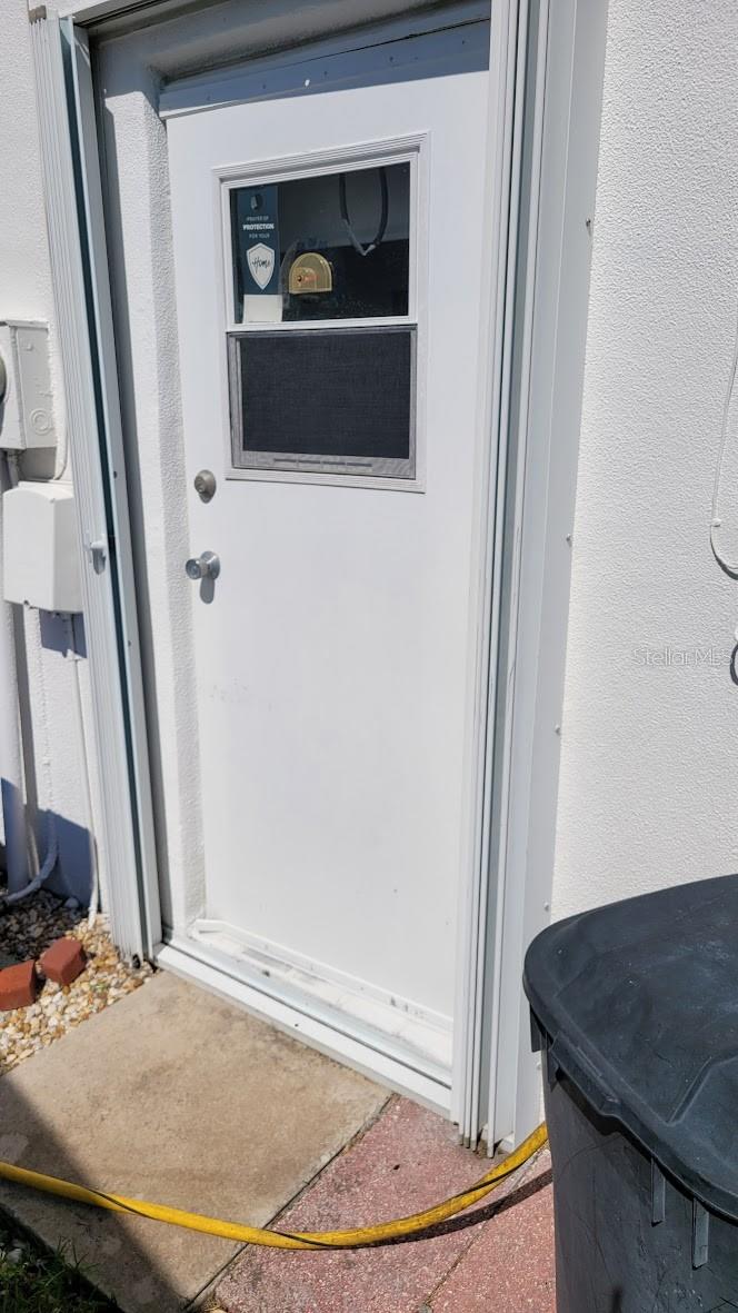 Garage side door and a hurricane shutter.