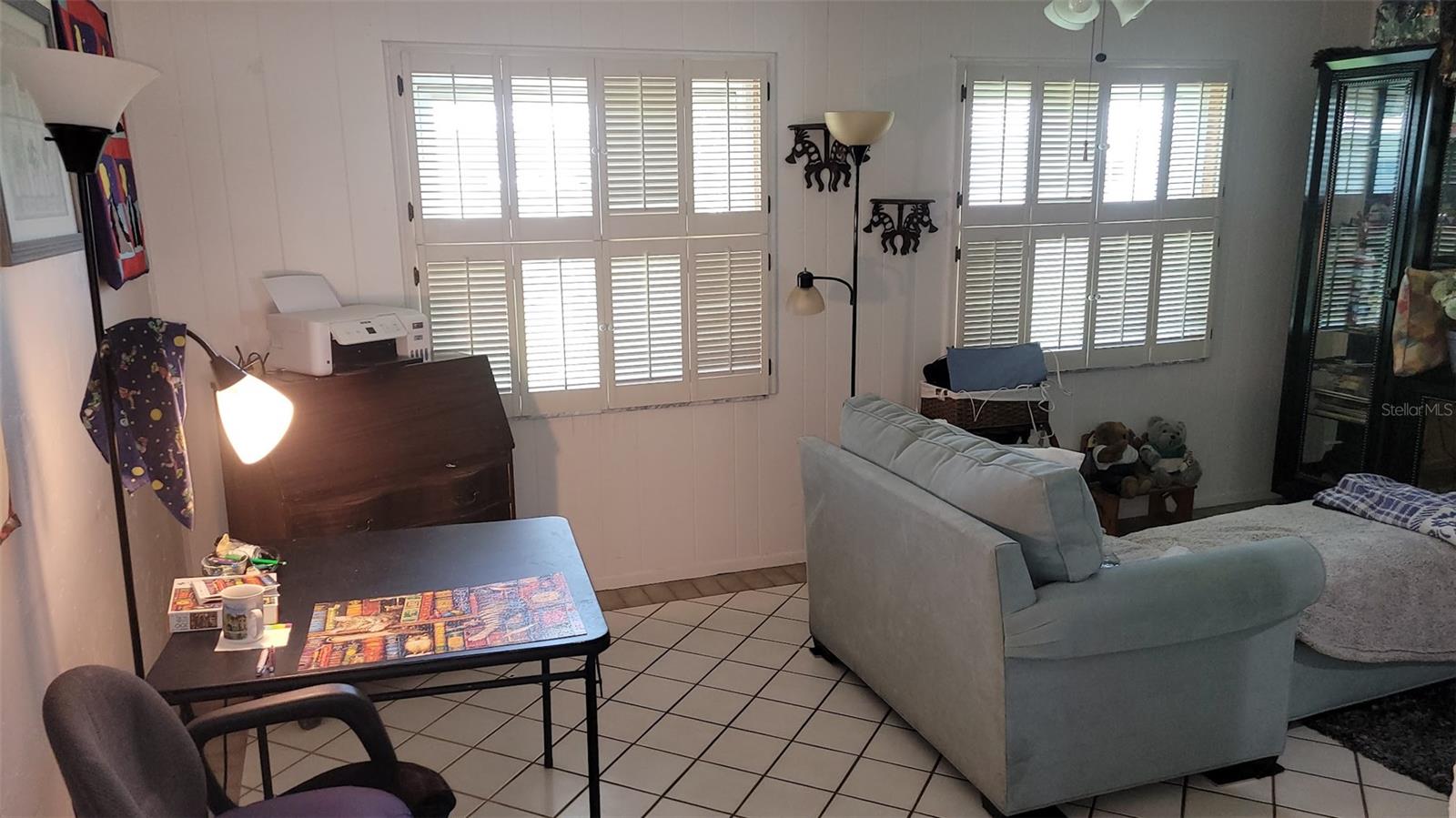 The seller enjoys working on puzzles, relaxing, and watching TV in this 11X18 room.