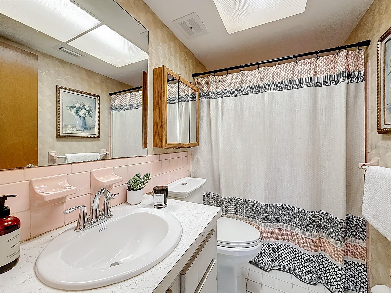 The bathroom has bathtub with a shower