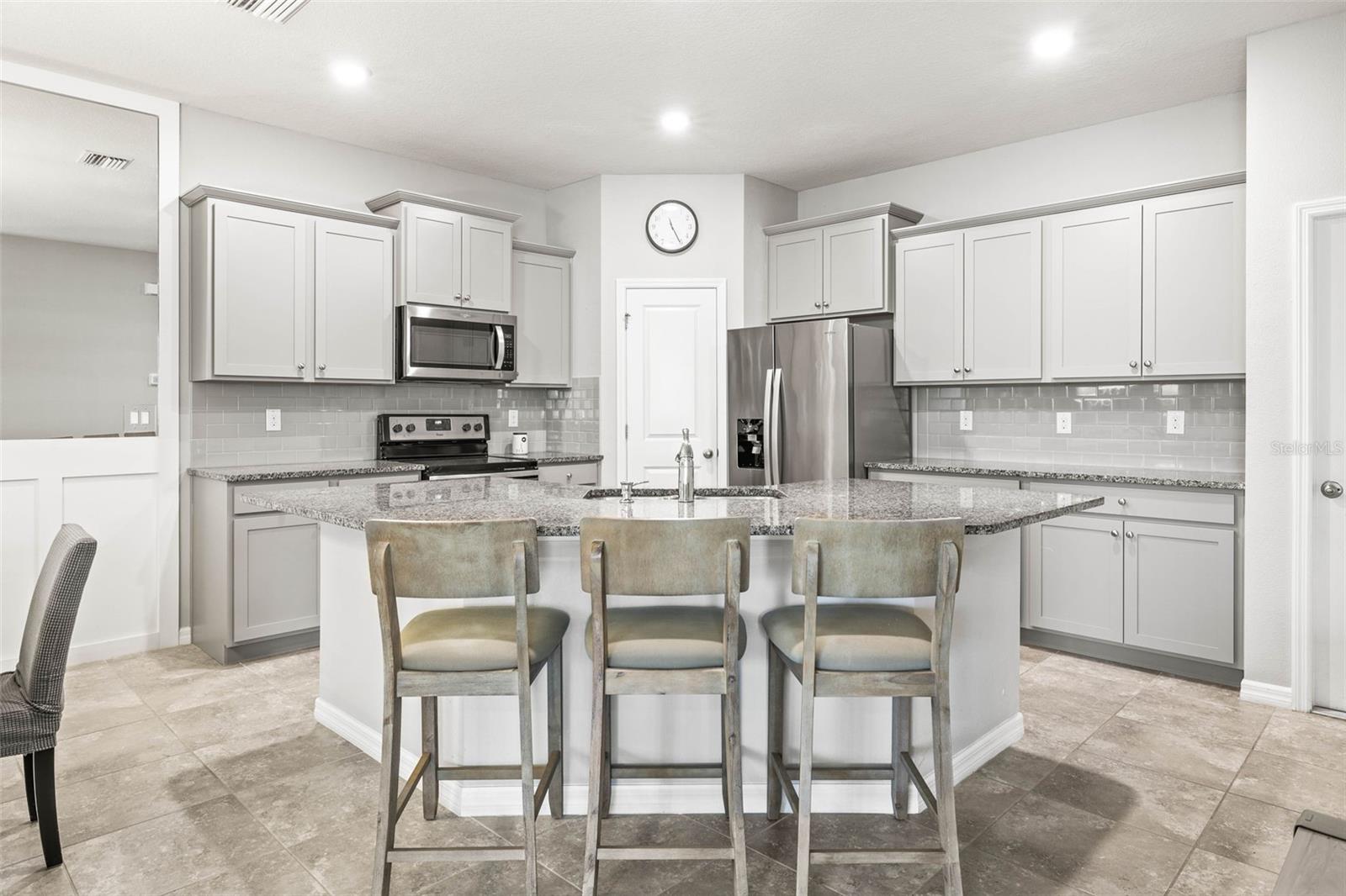 Your kitchen has crowned cabinetry, closet pantry, stainless steel appliances, quartz island for seating.