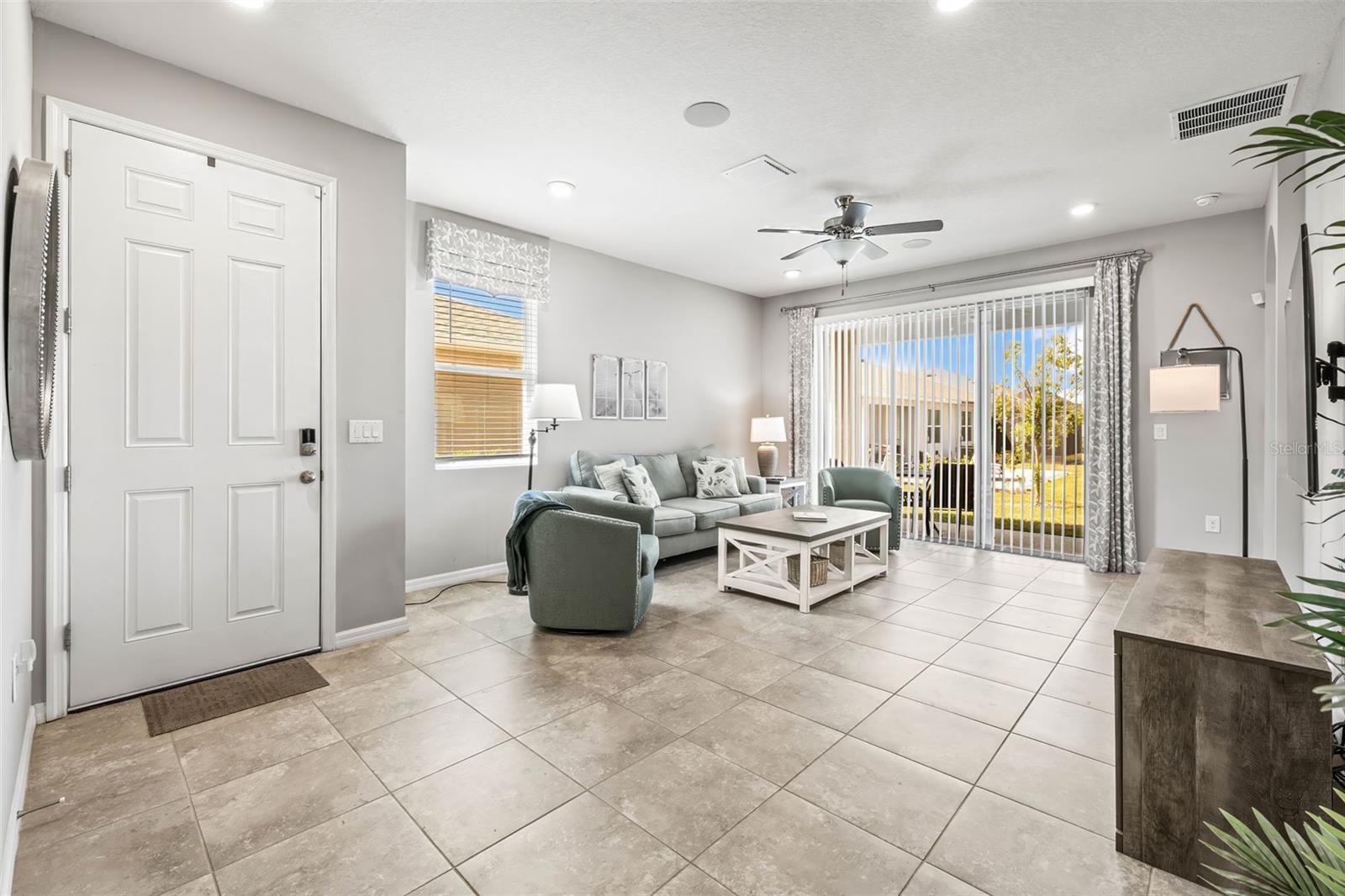 Your living room has tile flooring, bright natural light and a spacious open floor plan.