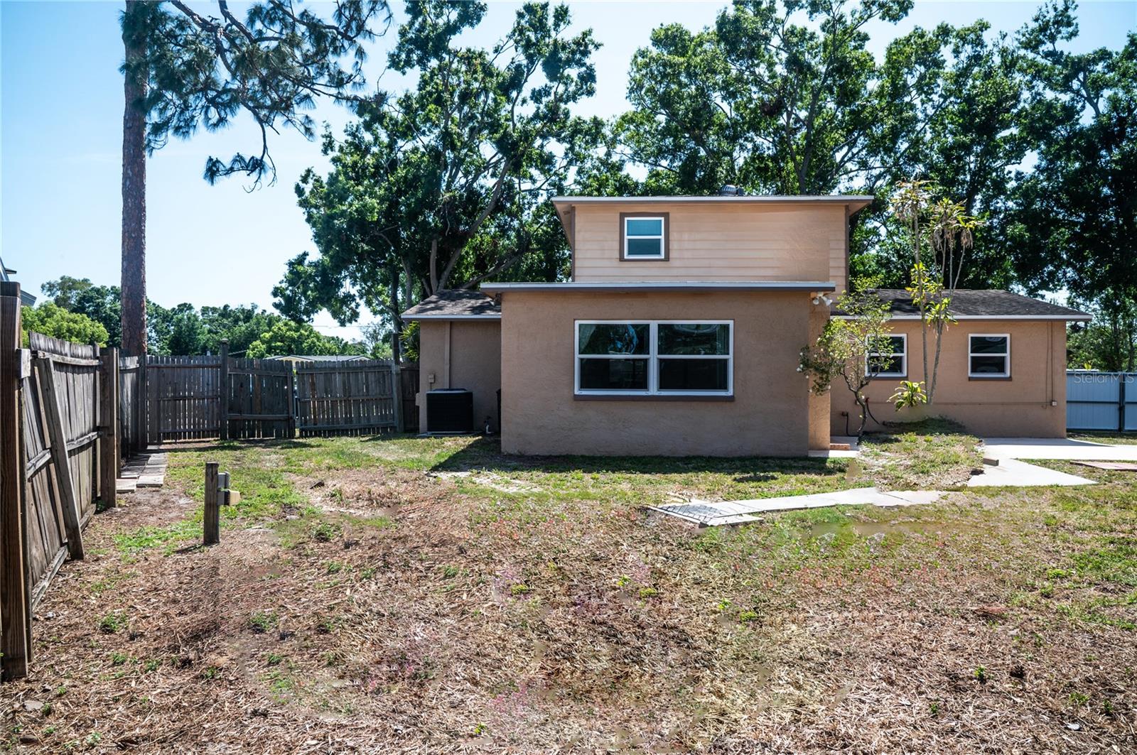 This backyard photo has been photoshopped to remove the boards on which the RV had previously been parked.