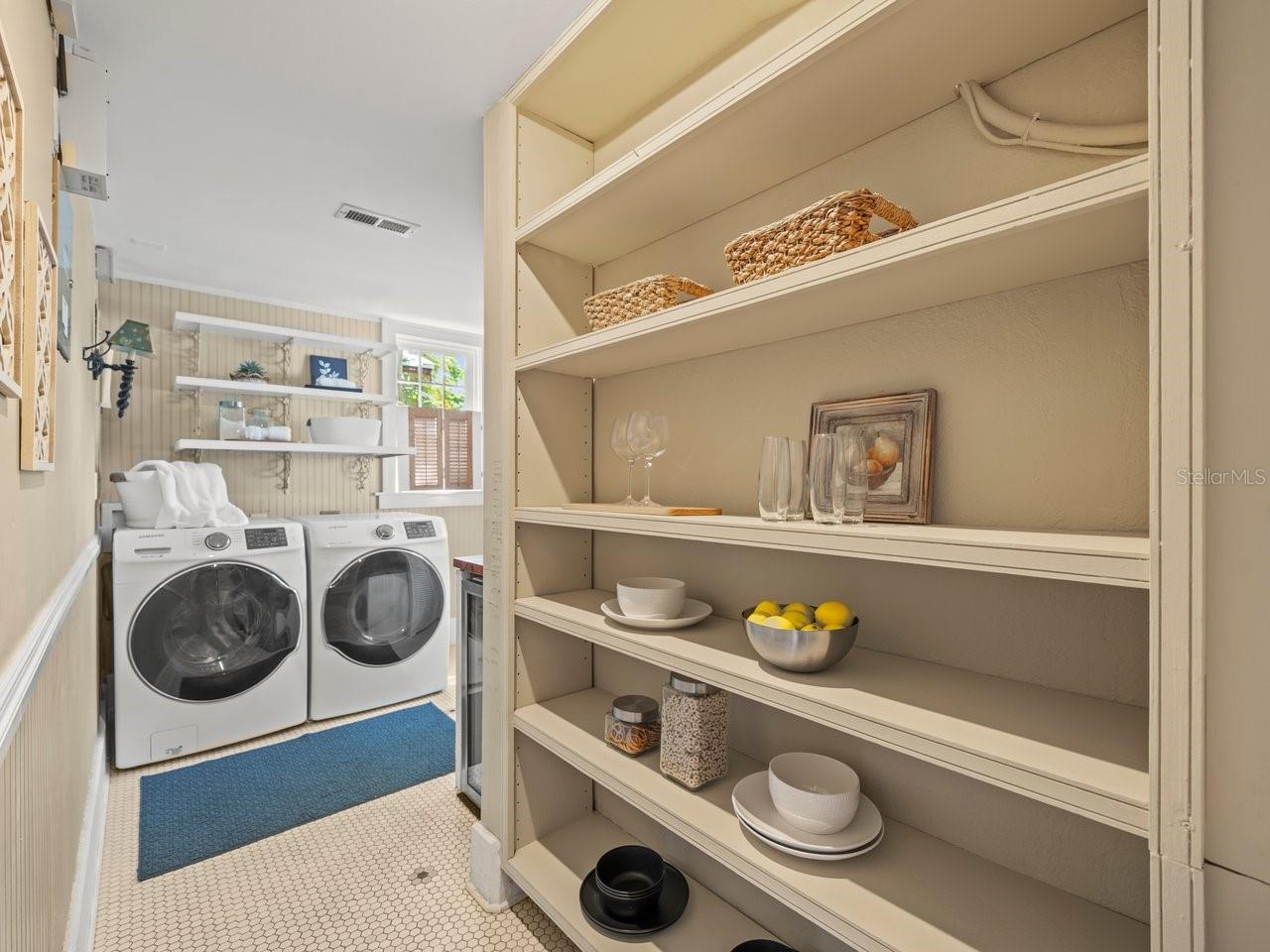 Substantial pantry and laundry room combo with exterior door to the back yard
