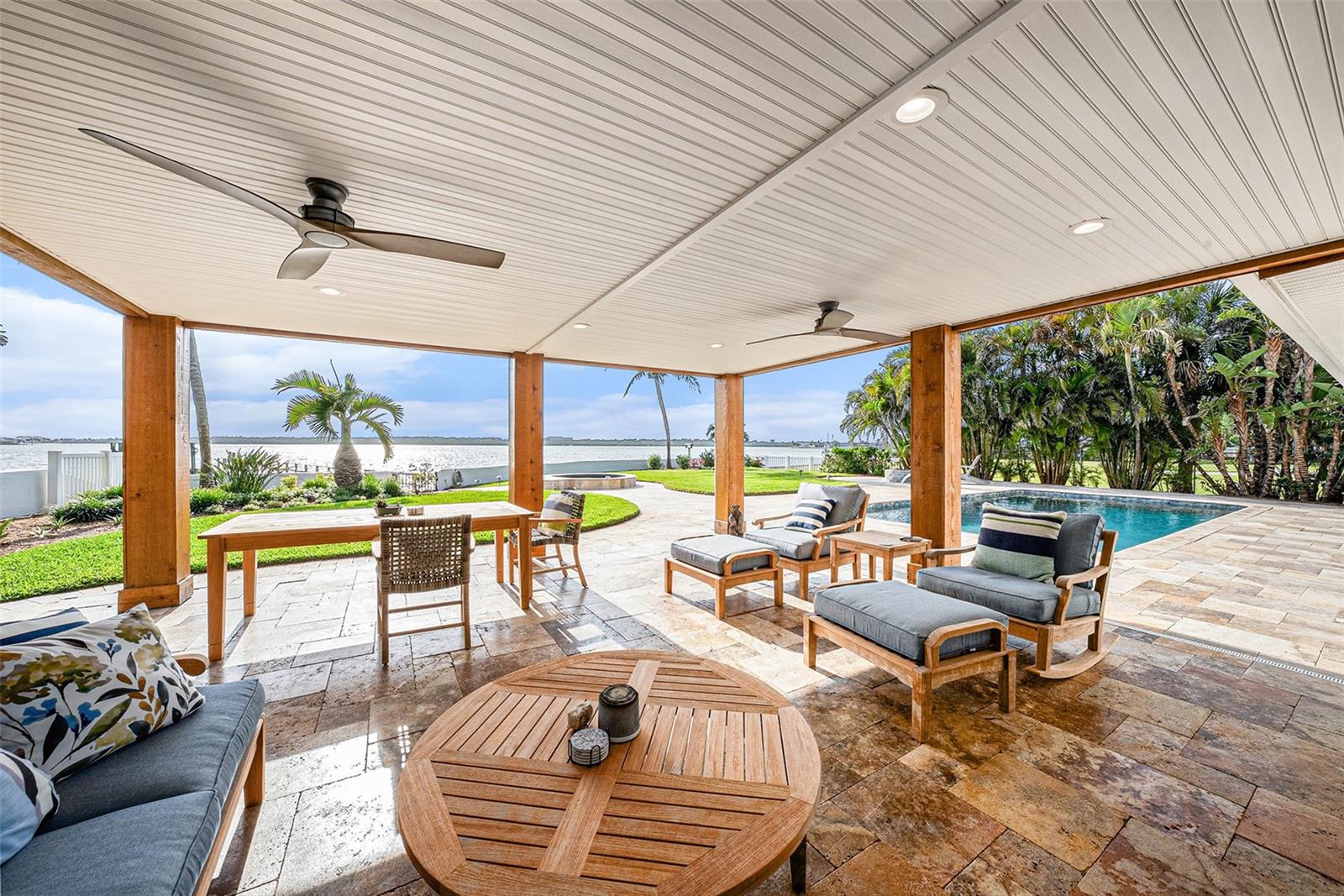 Stepping out from eat-in kitchen to covered Lanai, pool and outdoor fire pit