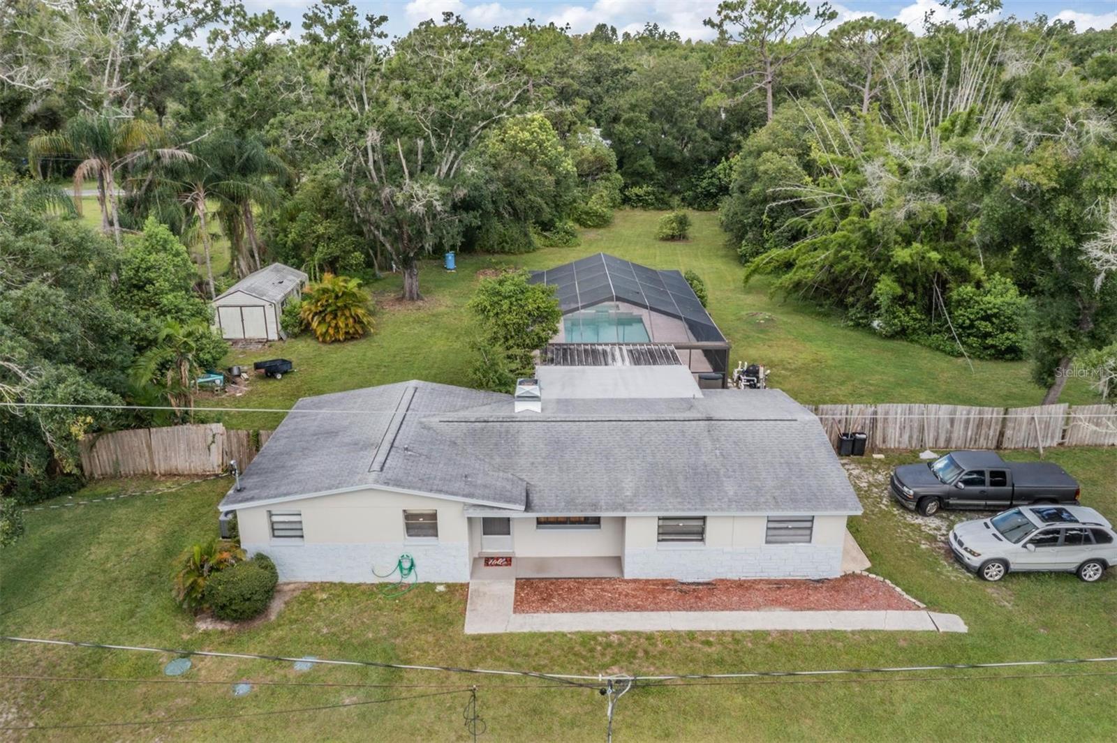 Beautiful 1.16 acre property in Carrollwood/Odessa 3 bedroom home with an amazing 37X15 screened pool and spa.