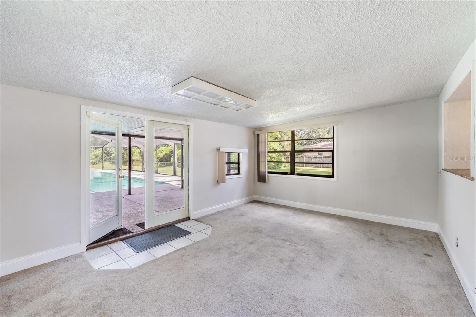 Family room with french doors to pool area