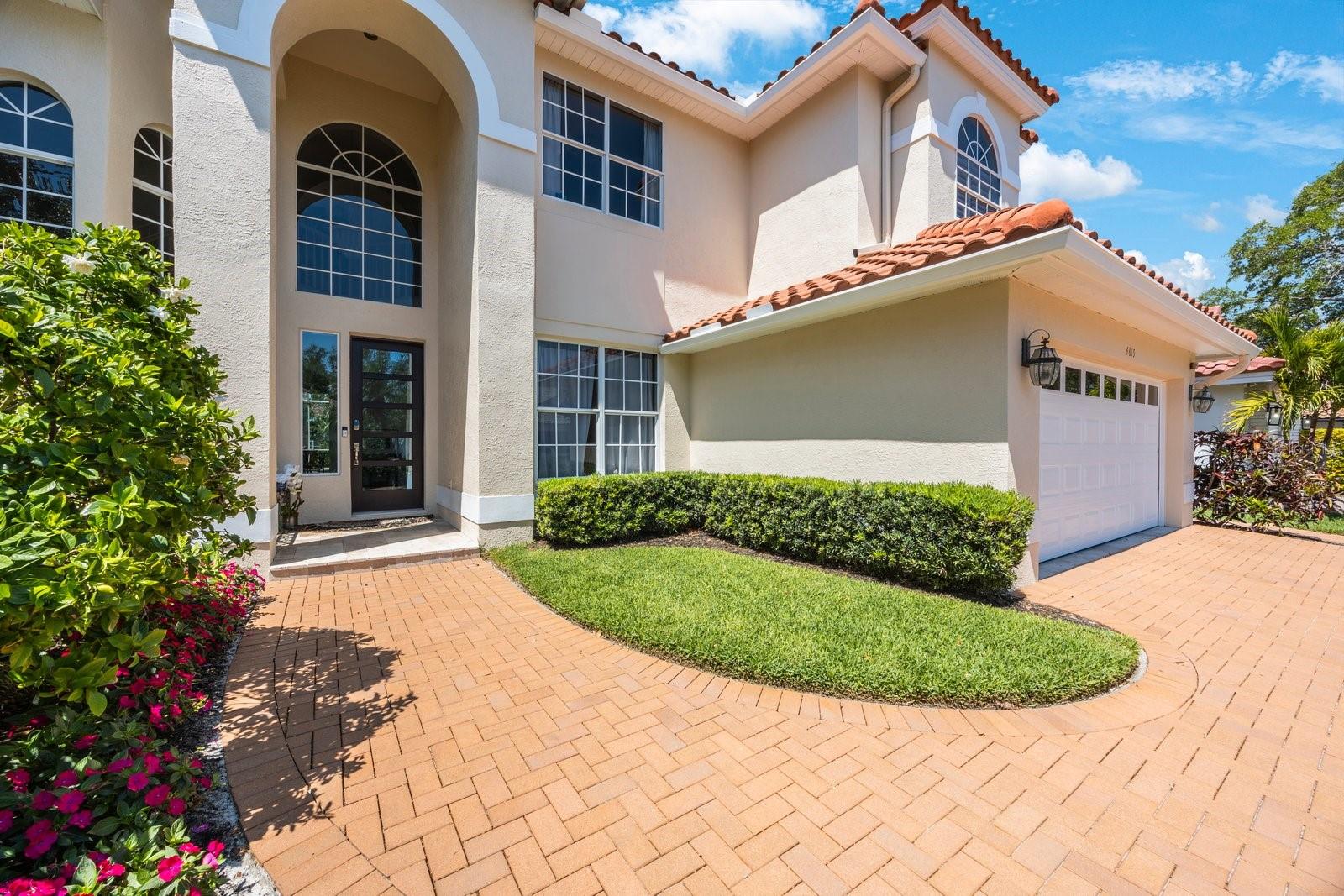 Brick walkway seamlessly leads to driveway