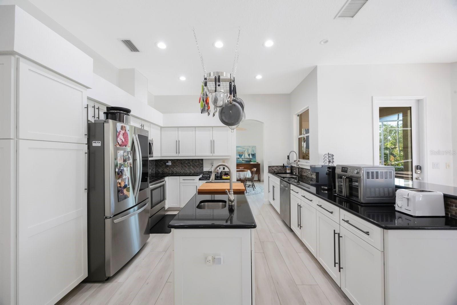 Center island provides counter space and storage along with a vegetable sink