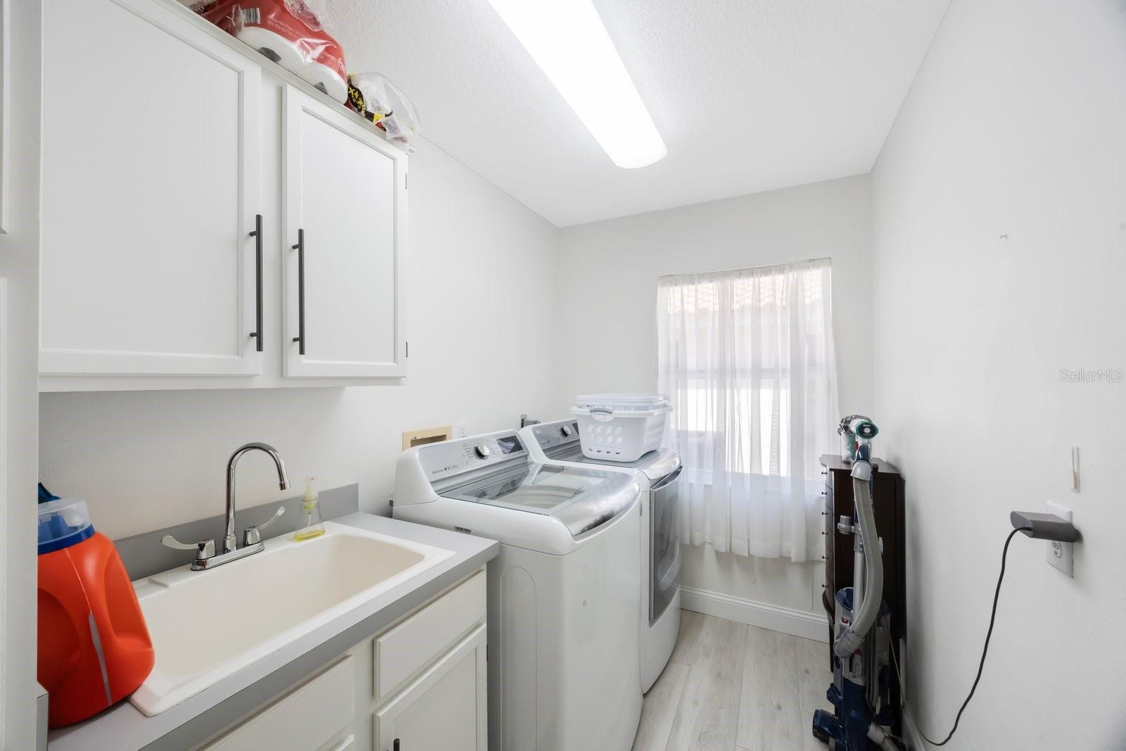 Large laundry room with storage just off the family room