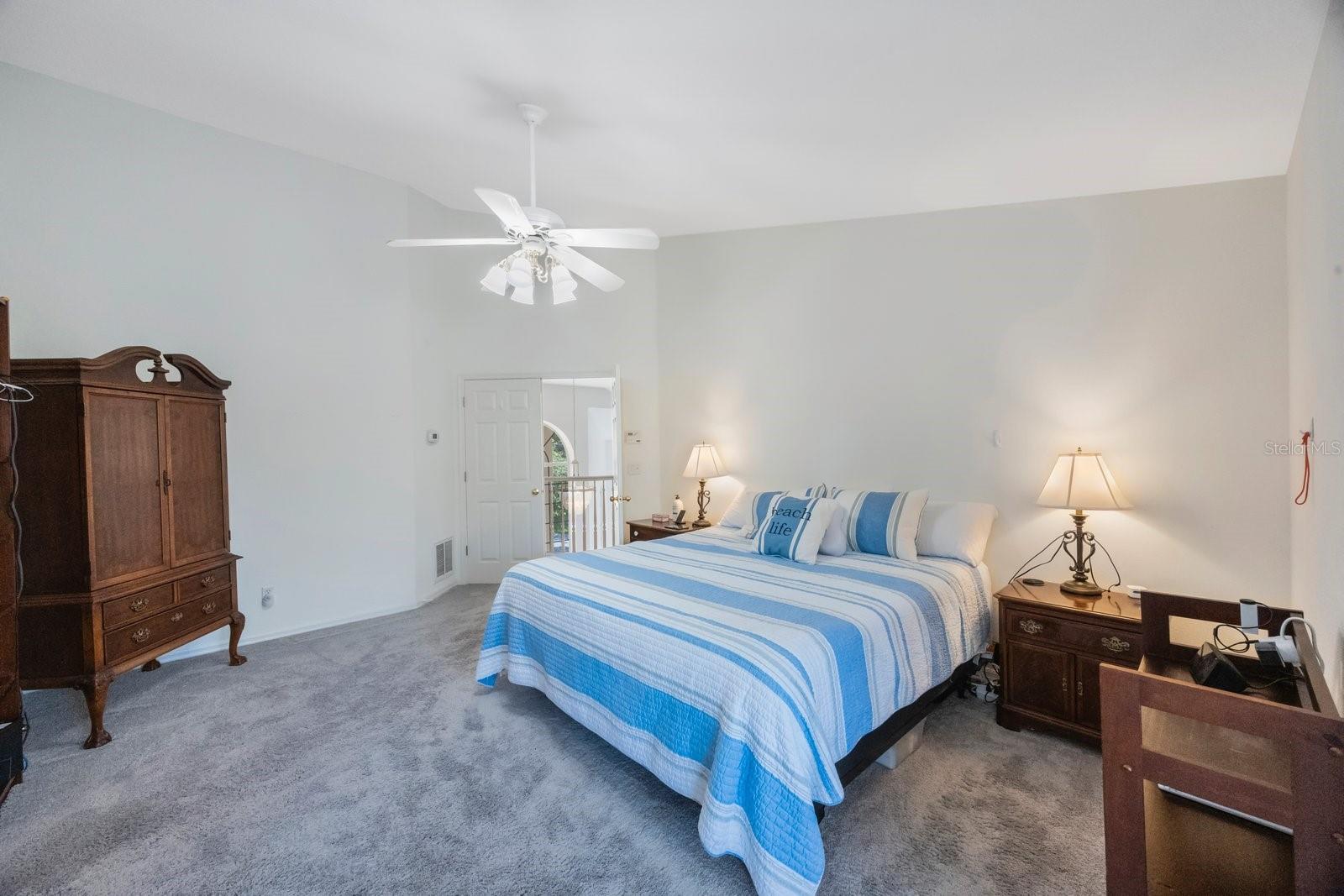 Large primary bedroom with his and hers walk-in closets and private balcony.  King-sized furniture shown