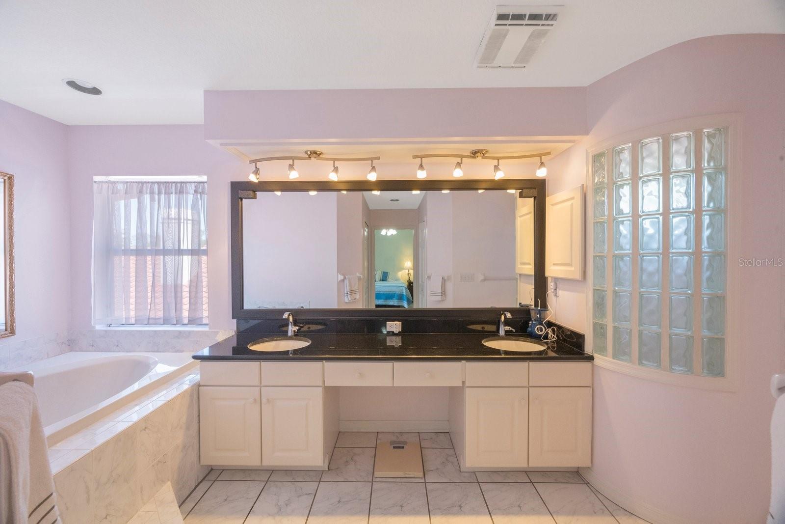 Primary bath with dual sinks, stand-up shower and jacuzzi/soaking tub