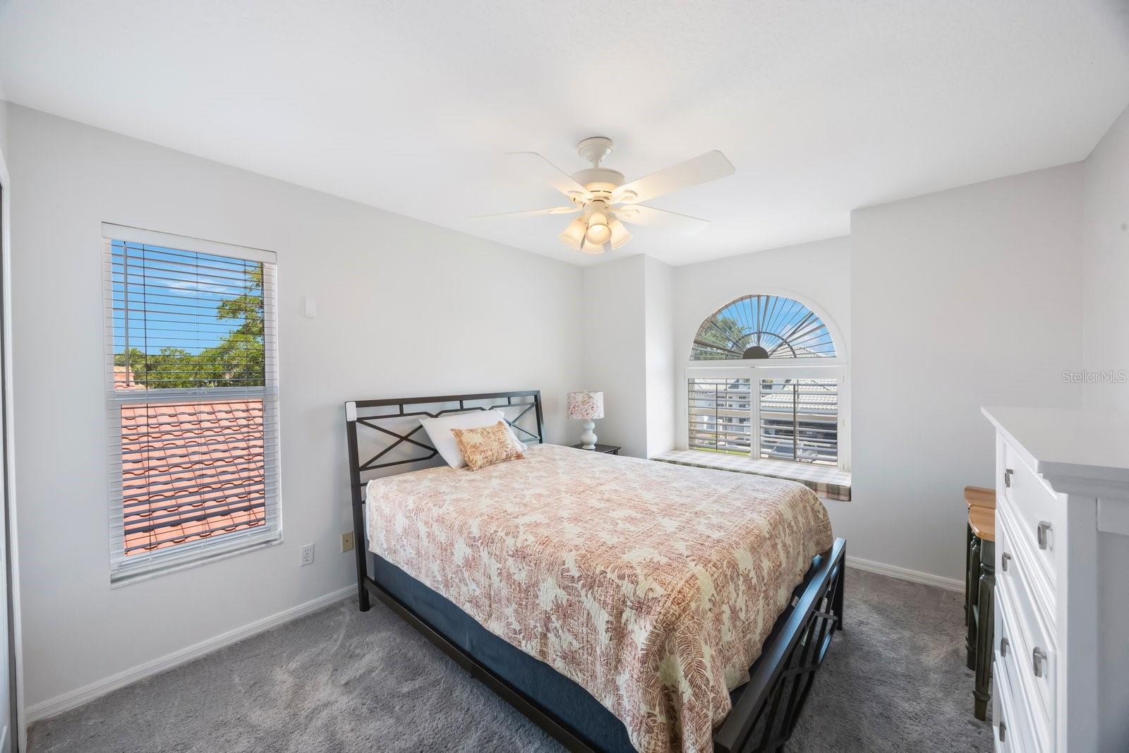Second bedroom, can accommodate king sized furniture, plantation shutters and window seat add southern charm