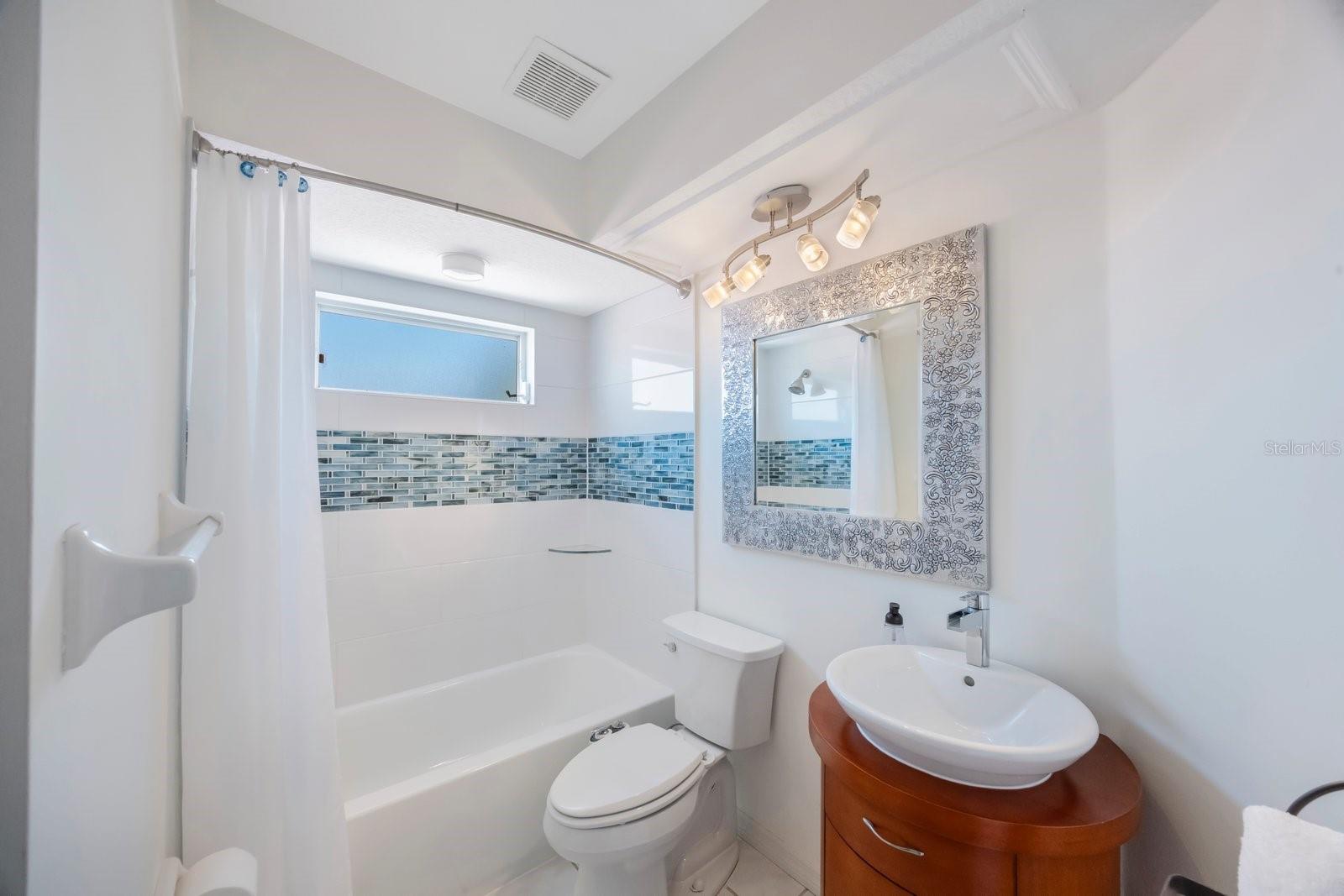 Second full bath with porcelain tub, toilet with bidet (conveys), Charming round vanity.   Serves upstairs second, third and fourth bedrooms.