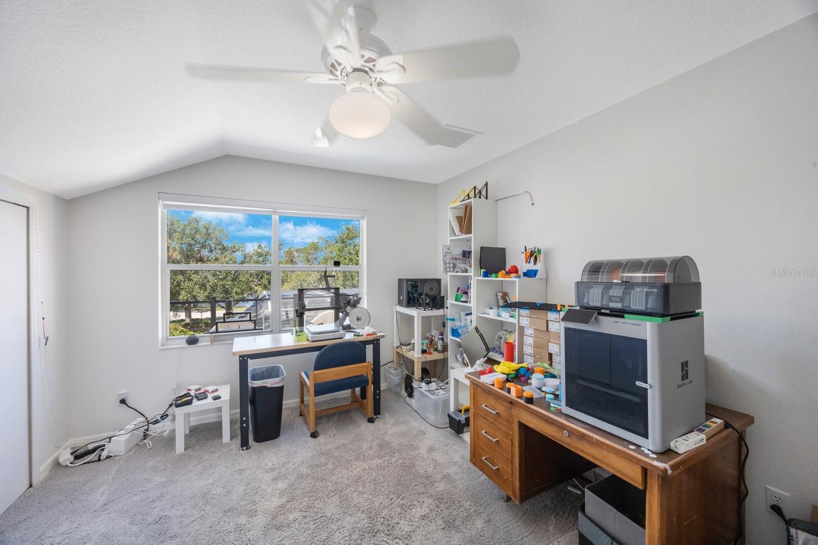 Fourth bedroom with plenty of light.  Currently functions as a 3D printer manufacturing plant.
