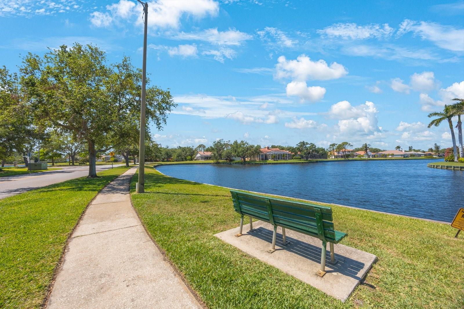 Take a walk around the lake or relax on the bench just across from your property