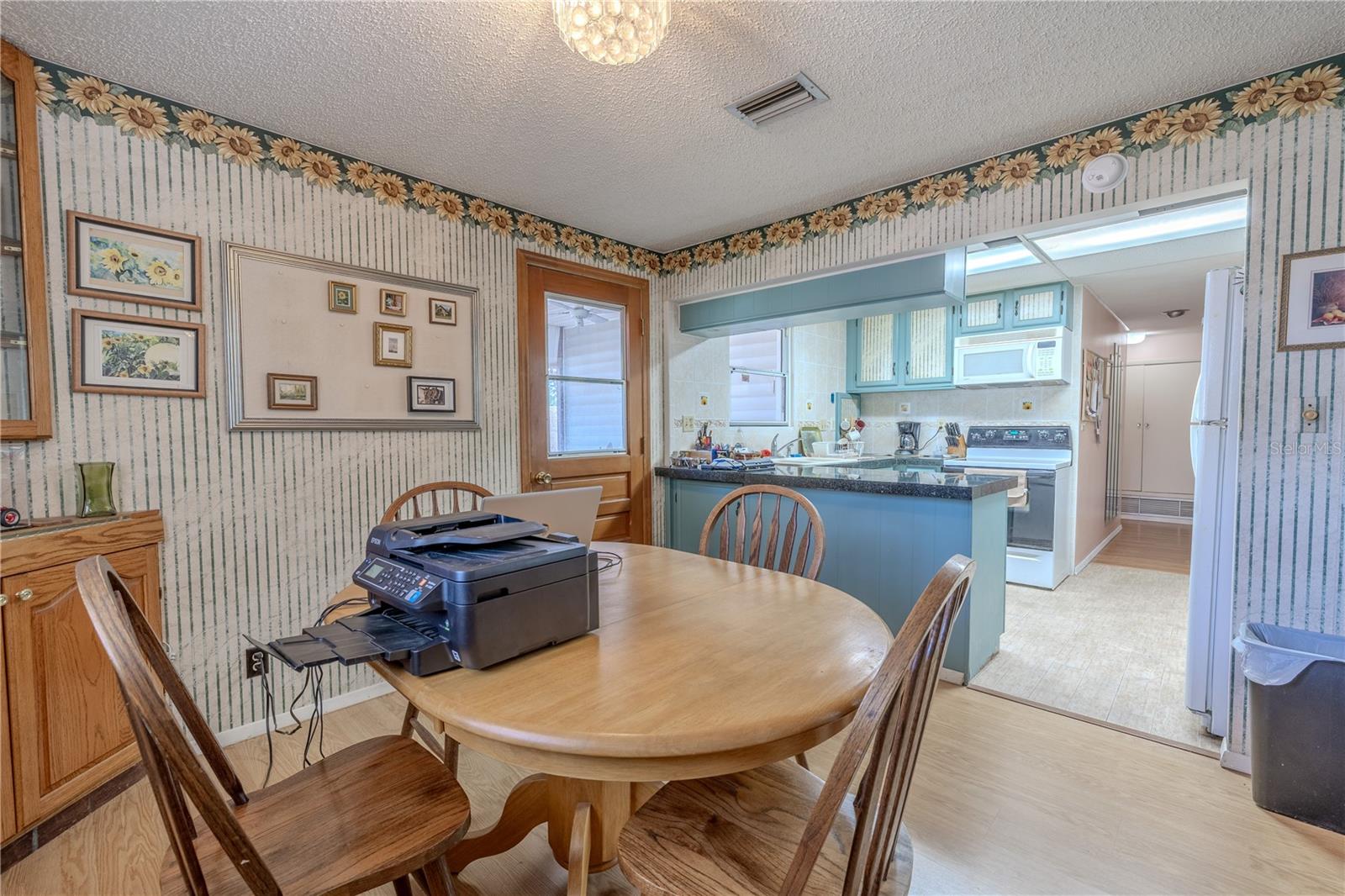 The kitchen features a breakfast bar and is open to the dinette.